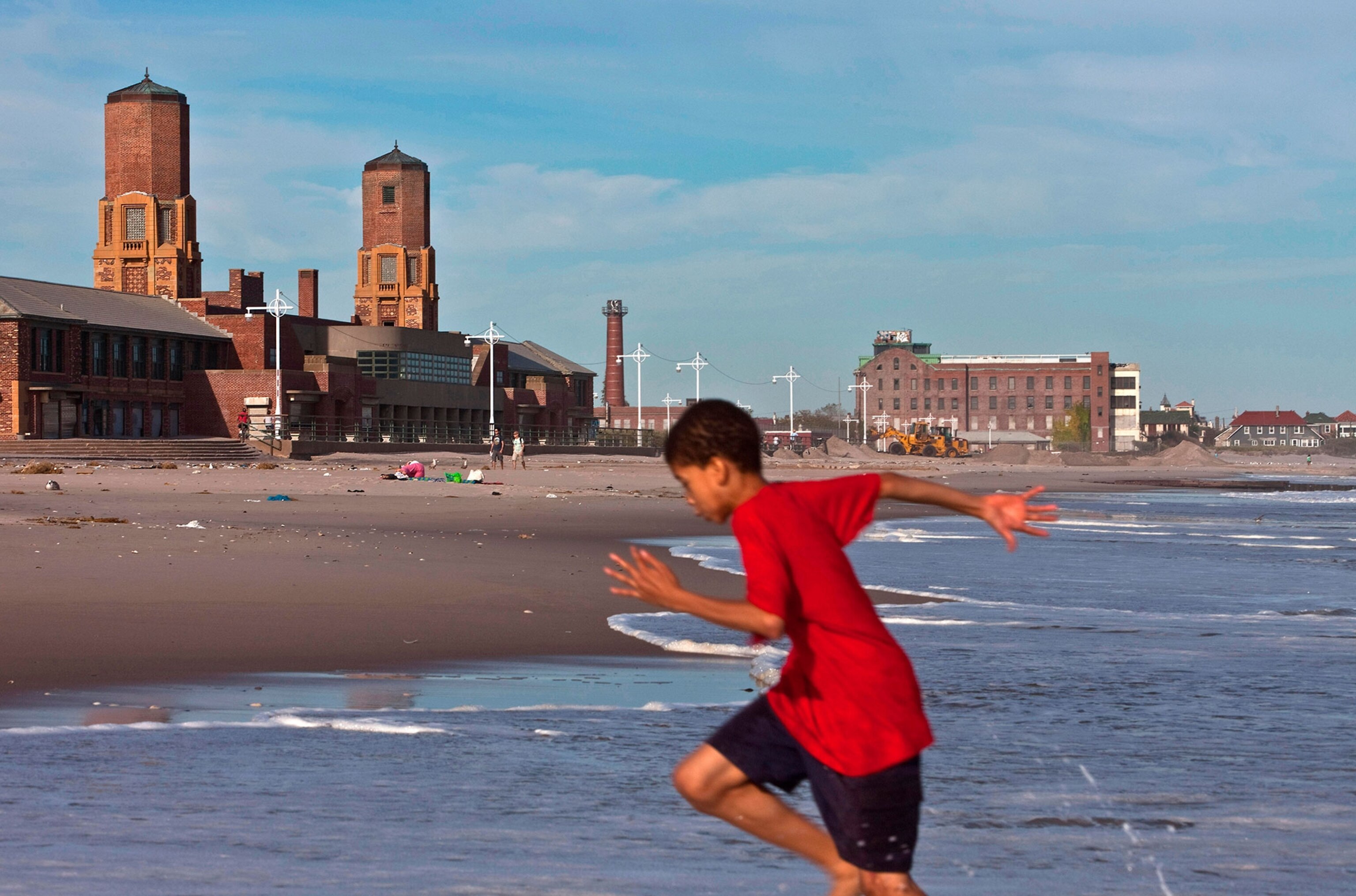 a boy running on a beach