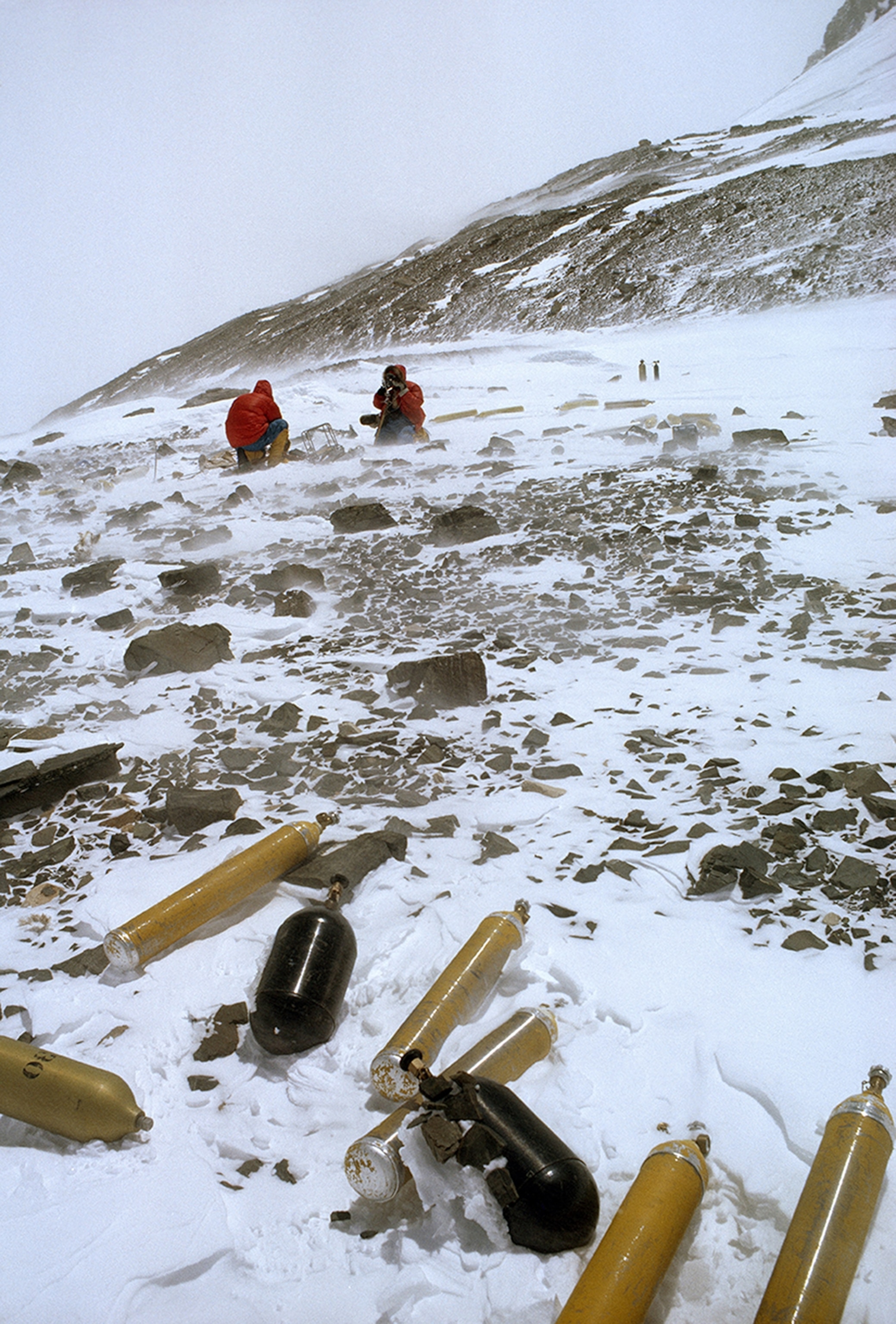 World’s high junkyard. Castoff oxygen bottles and other equipment from previous expeditions little South Col at 26,200 feet. Rummagers found two full bottles.