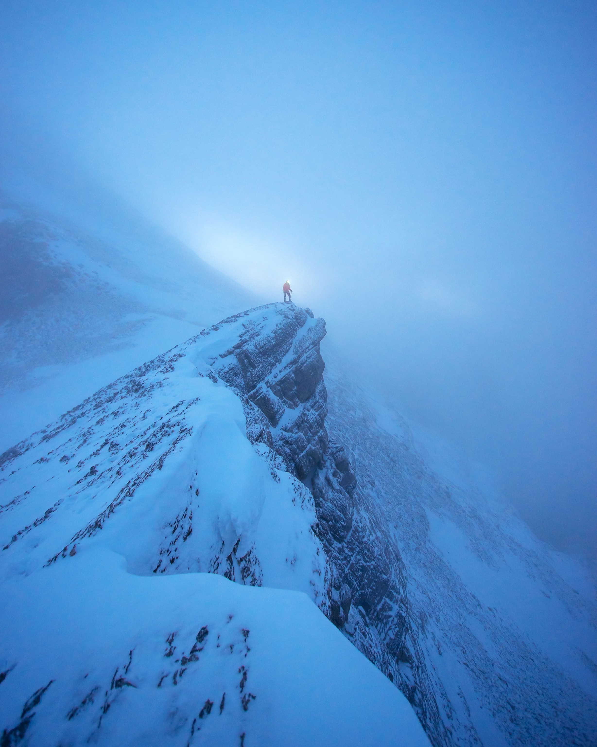 a man standing on a rock ledge in Nordegg Alberta