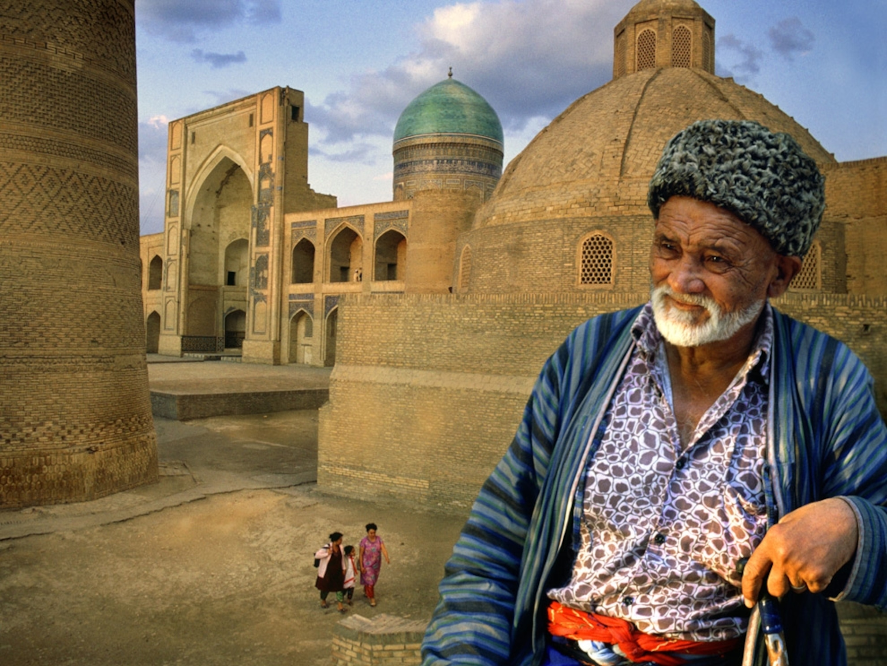 A man in front of a mosque