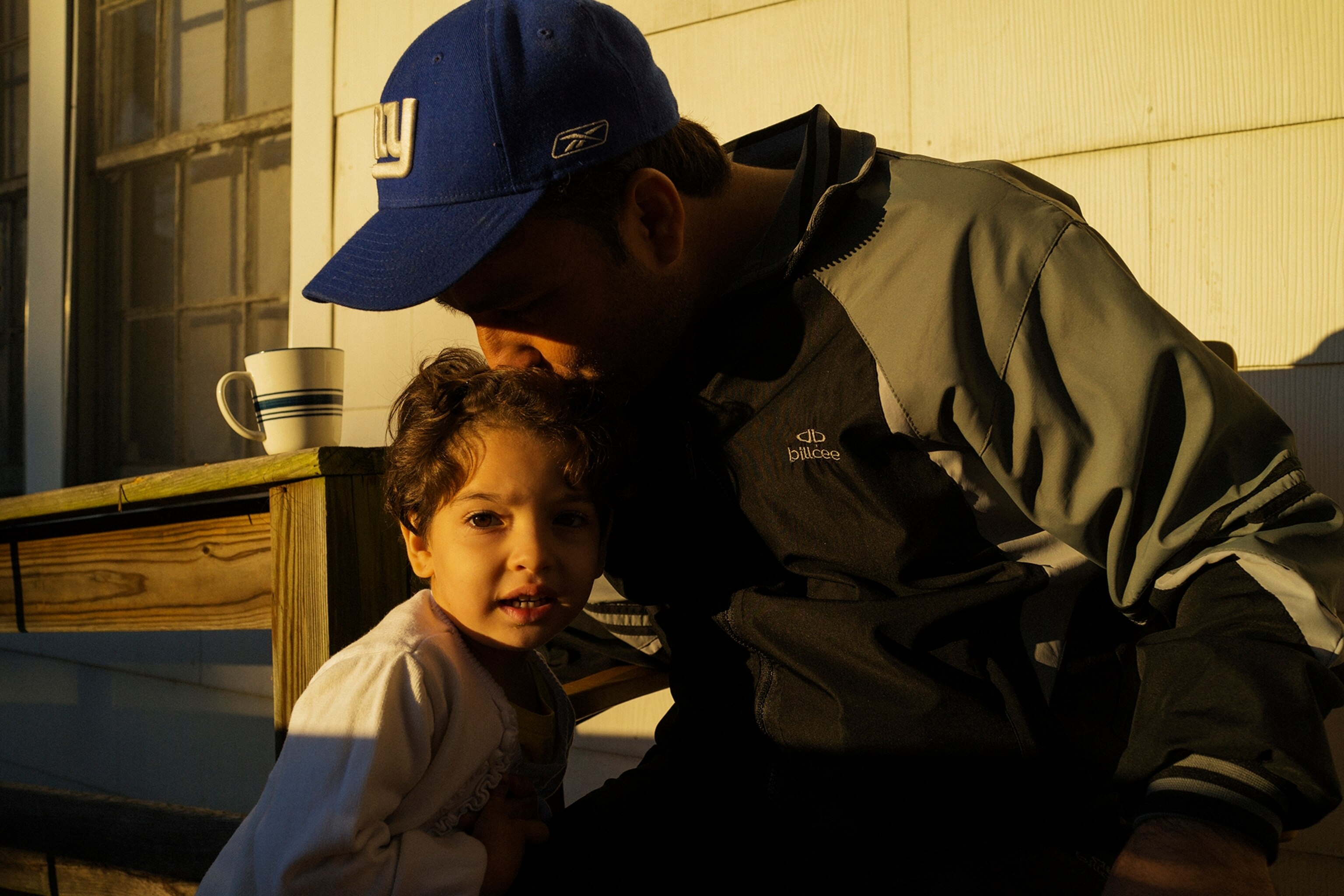 a man kissing his child's head