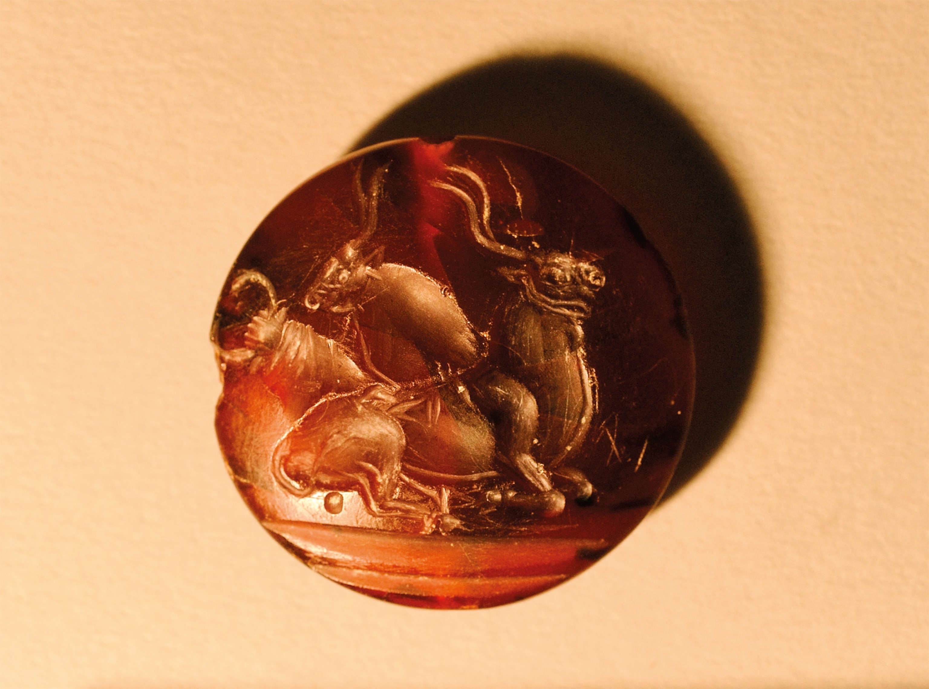 More than 50 sealstones, like this carnelian one featuring three bulls, were found in the Griffin Warrior’s tomb.