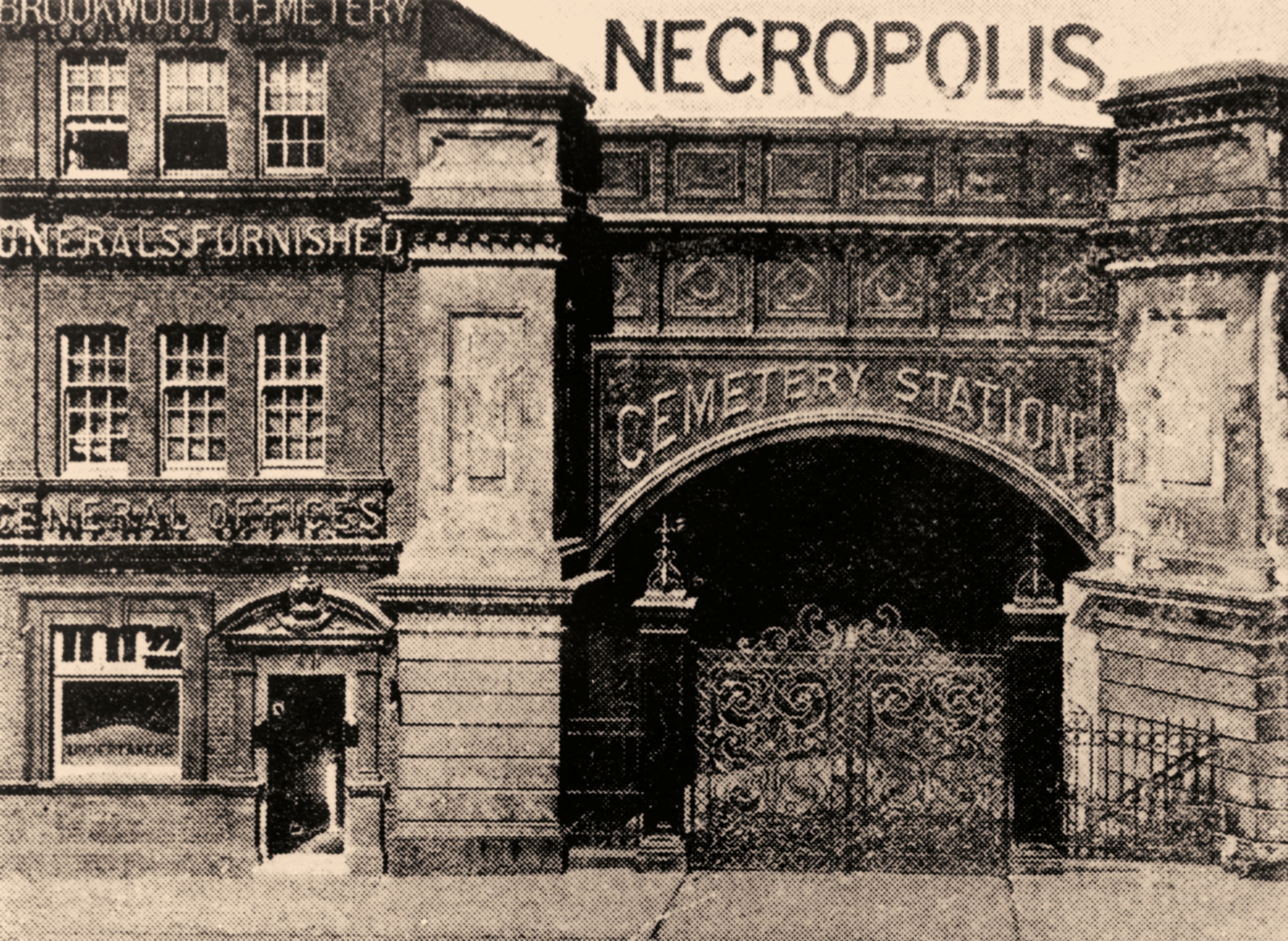 An archway on a building has a sign reading Necropolis cemetery station
