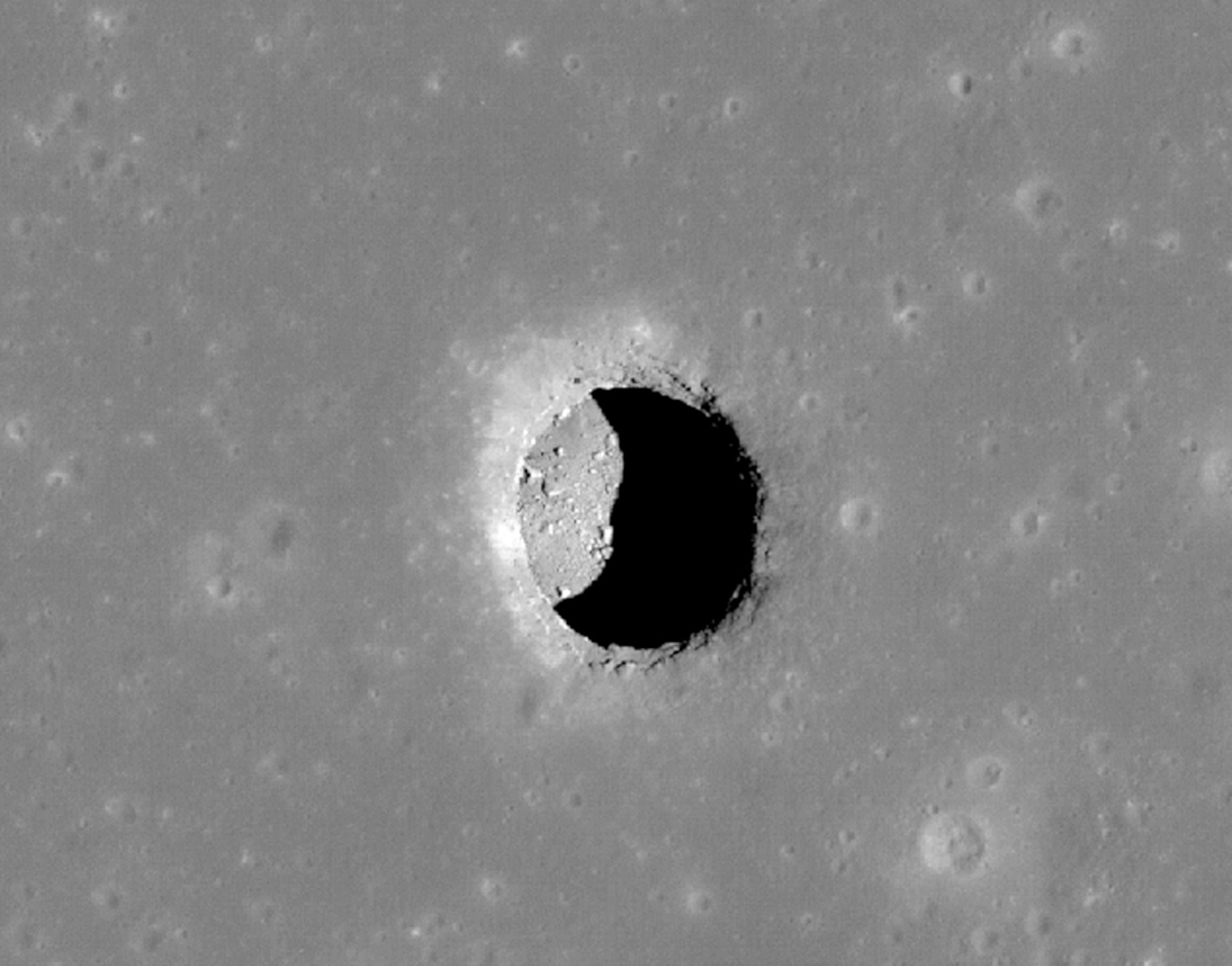 Picture of a deep pit on the moon.
