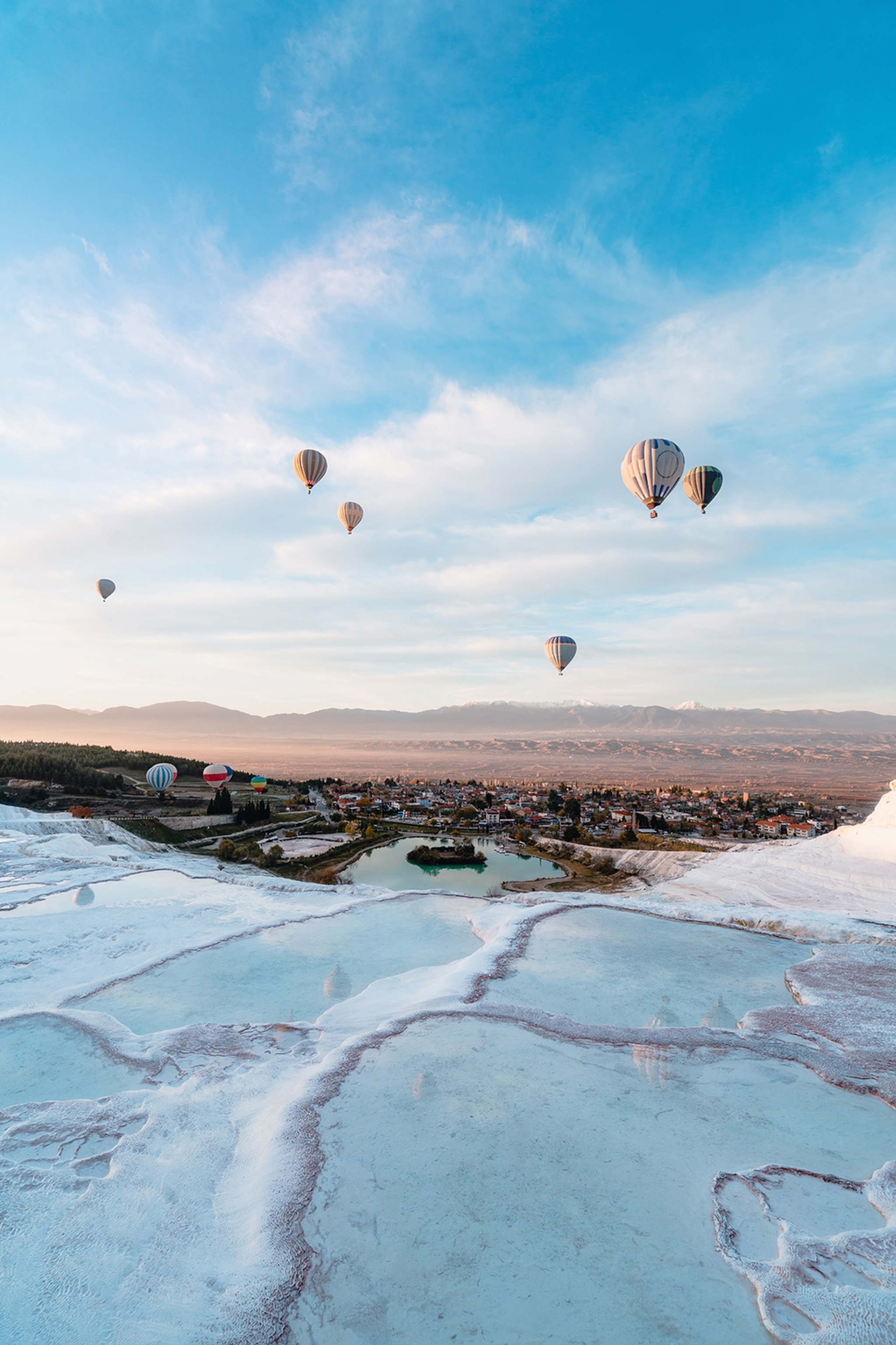 Hot air balloons above hot springs.