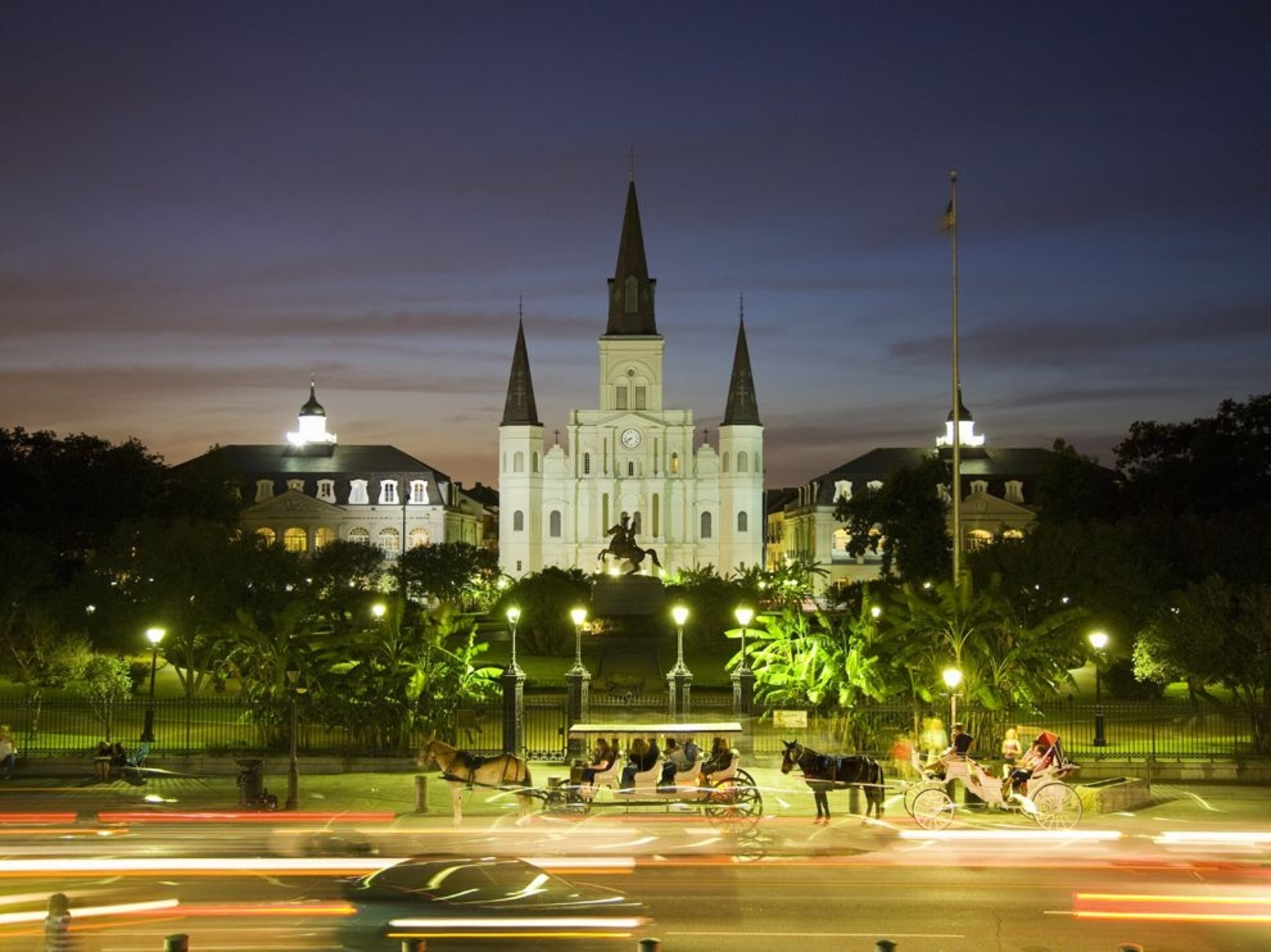 St. Louis Catherdral and horse drawn carriages at dusk