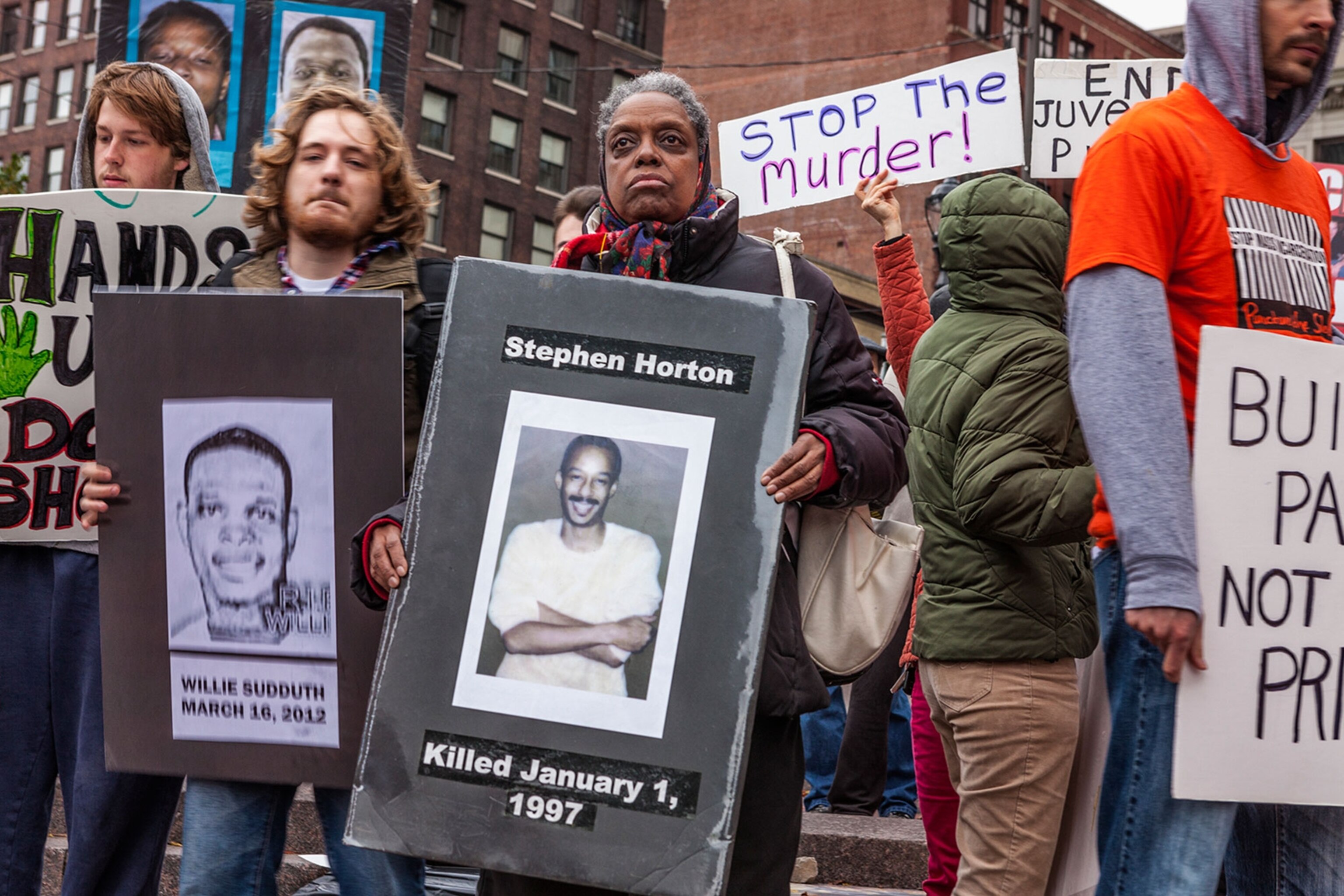 protestors holding signs and images protesting police brutality