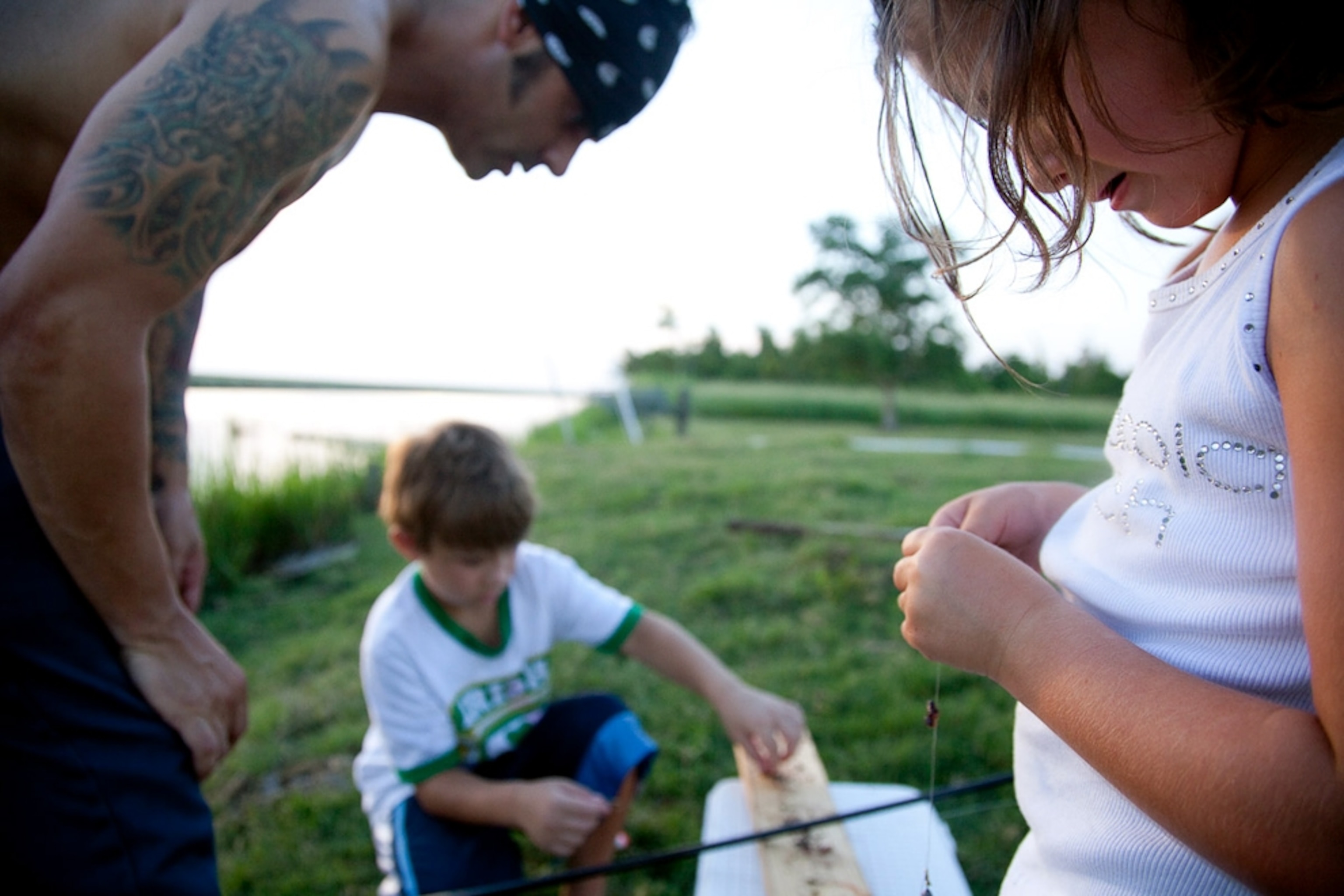 Three people preparing fishing line