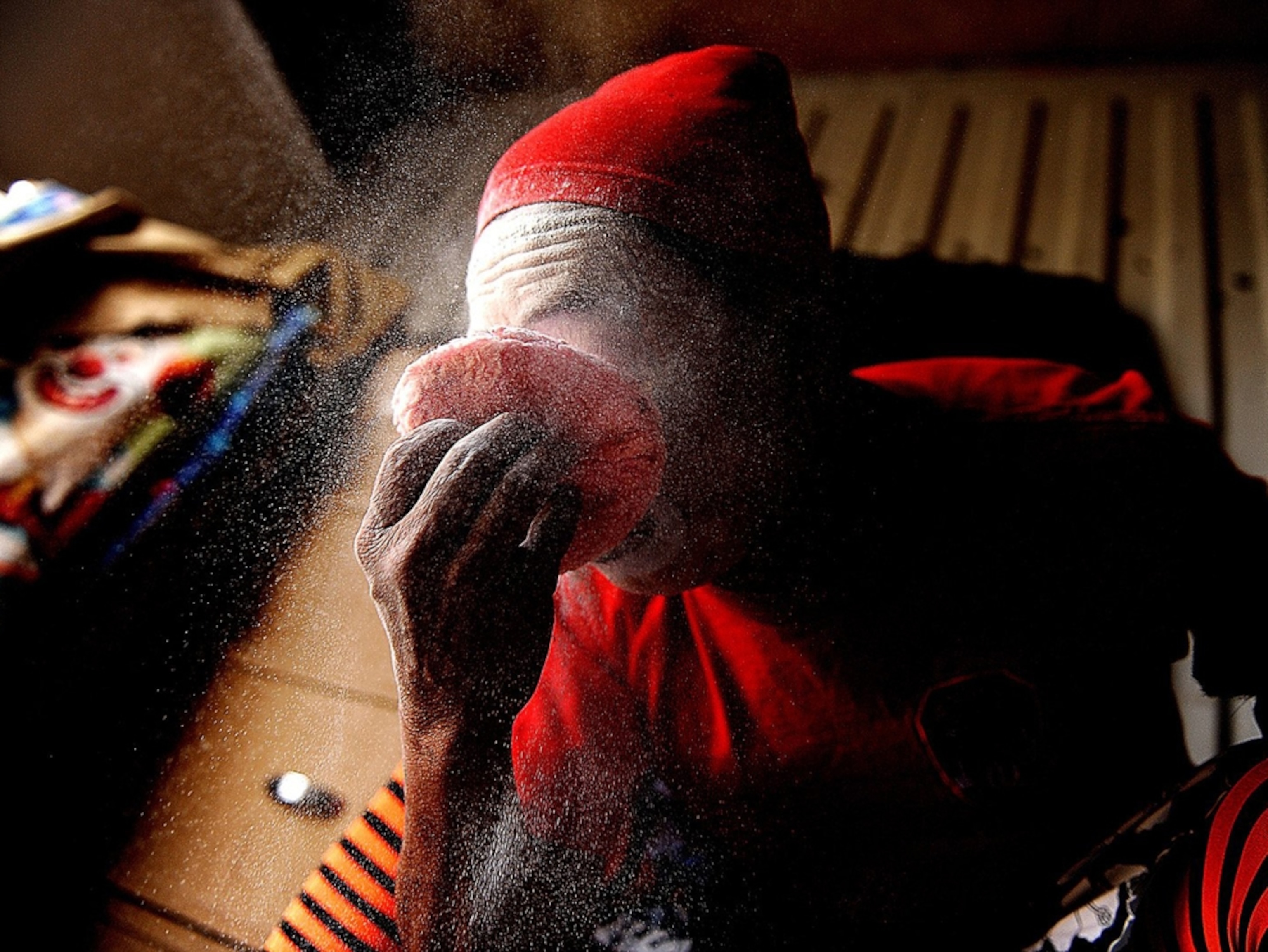 Circus clown applying makeup