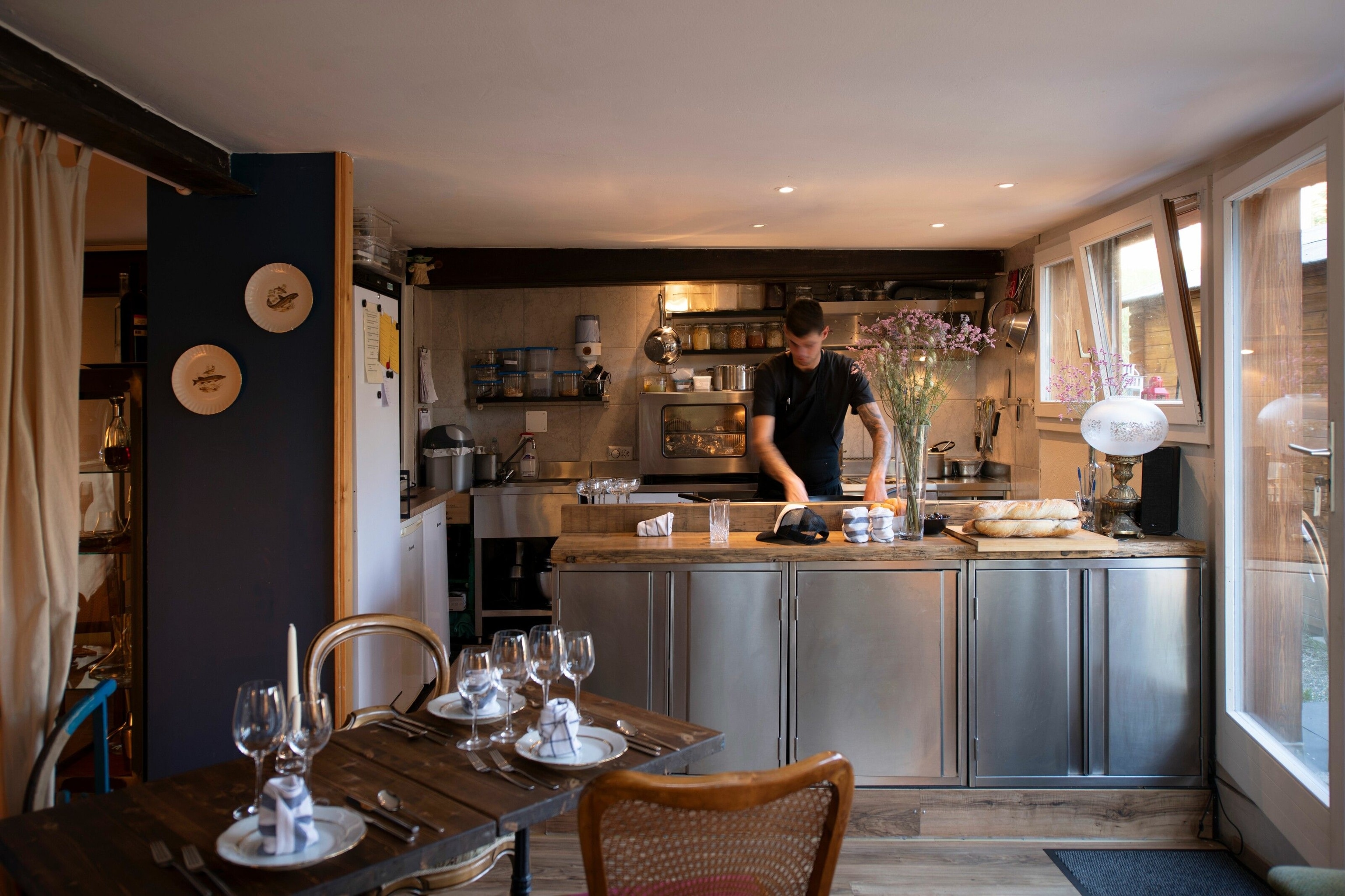 Chef preparing a dish in an open kitchen of a restaurant