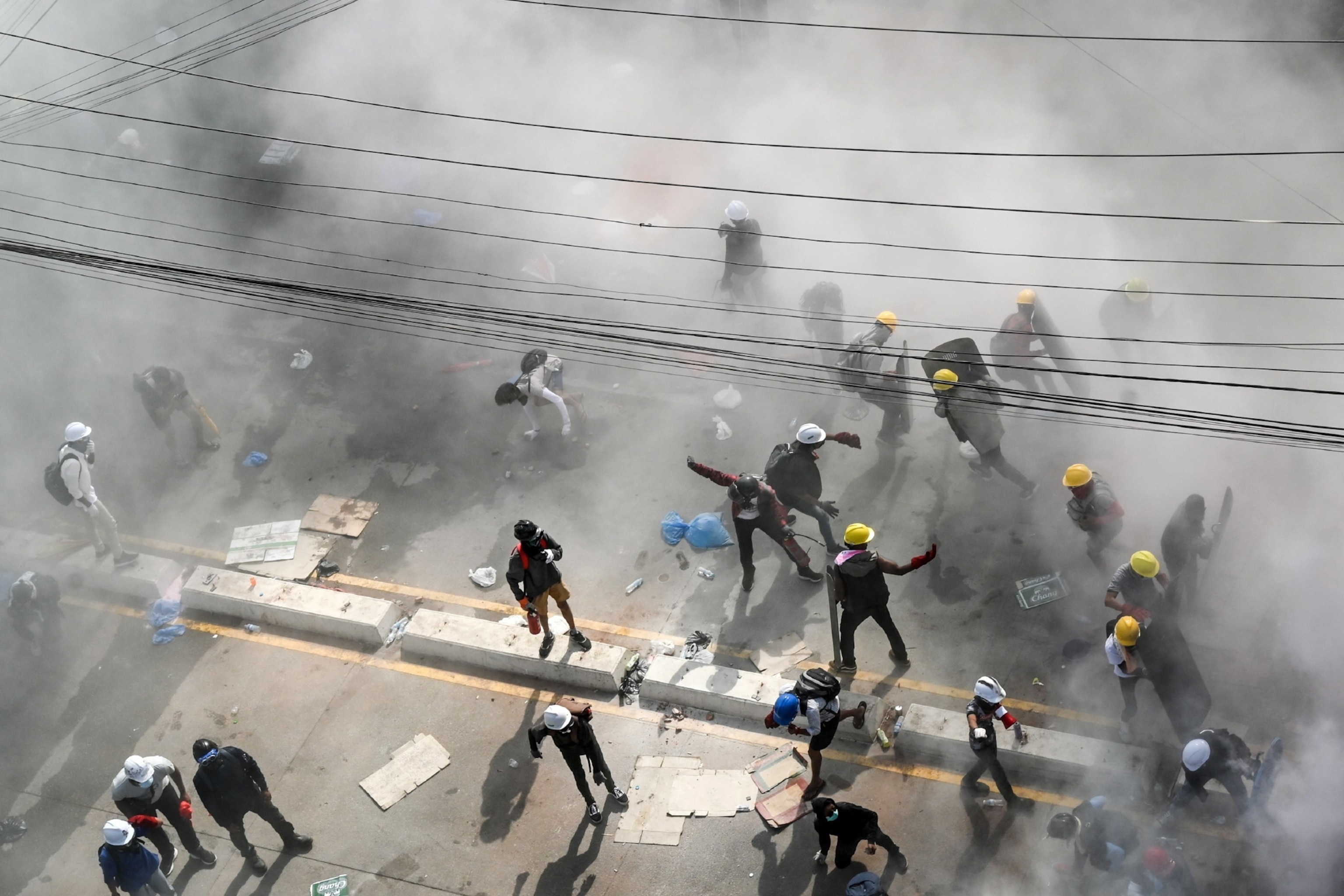 People protest among a cloud of tear gas