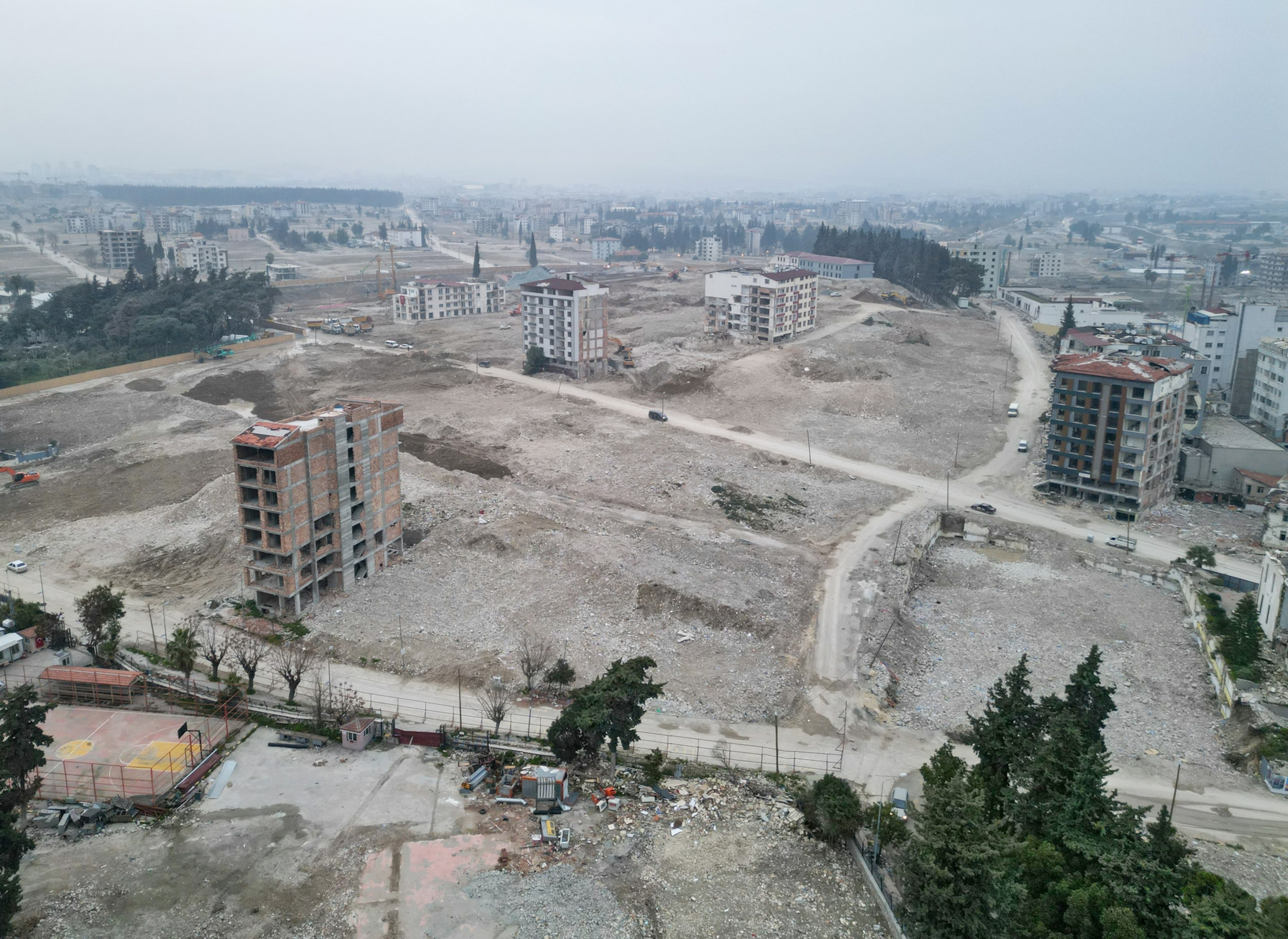 A few tall building's shells standing on bare ground.