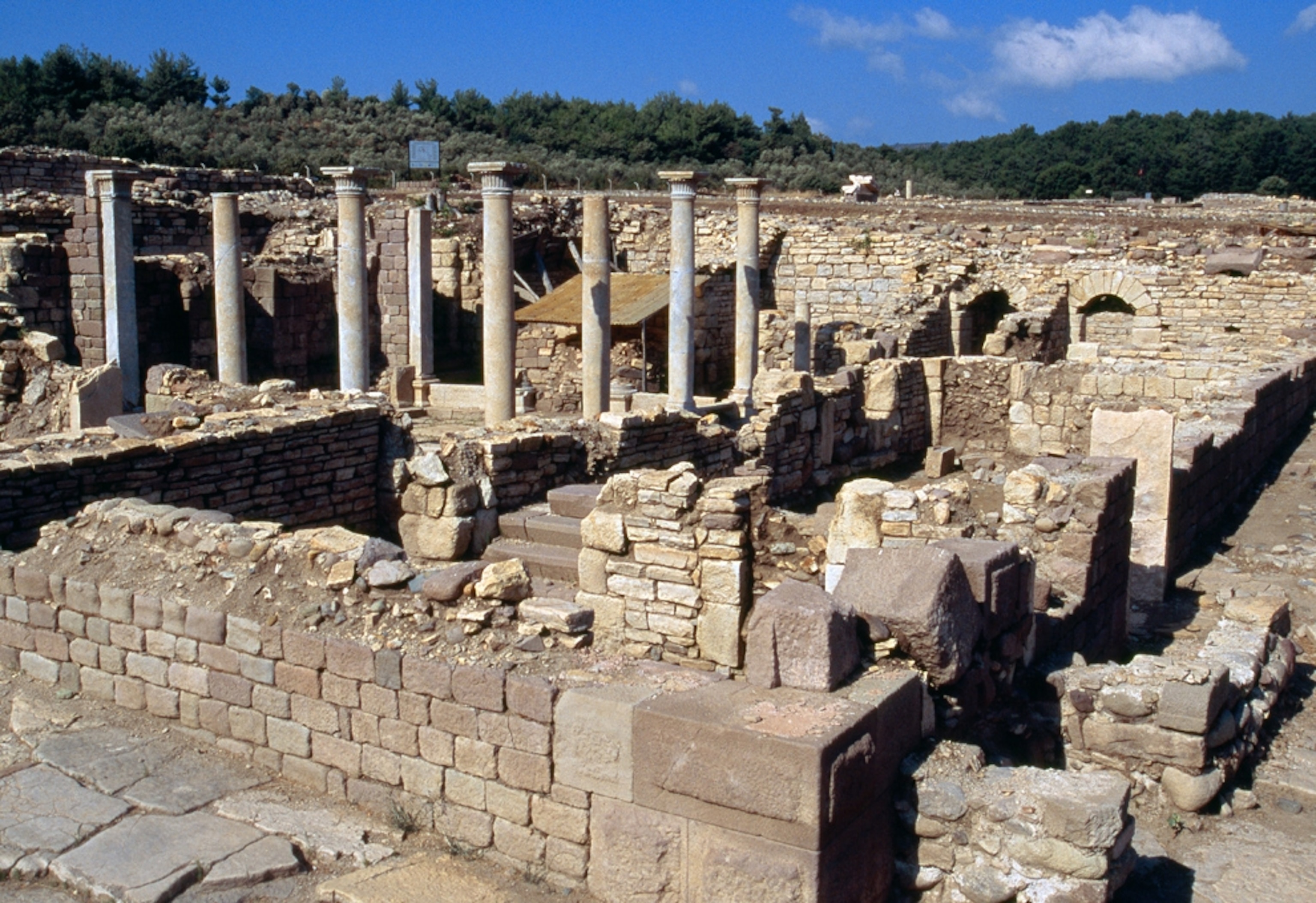 The columns and foundations of the Roman baths at Allianoi under a blue sky.
