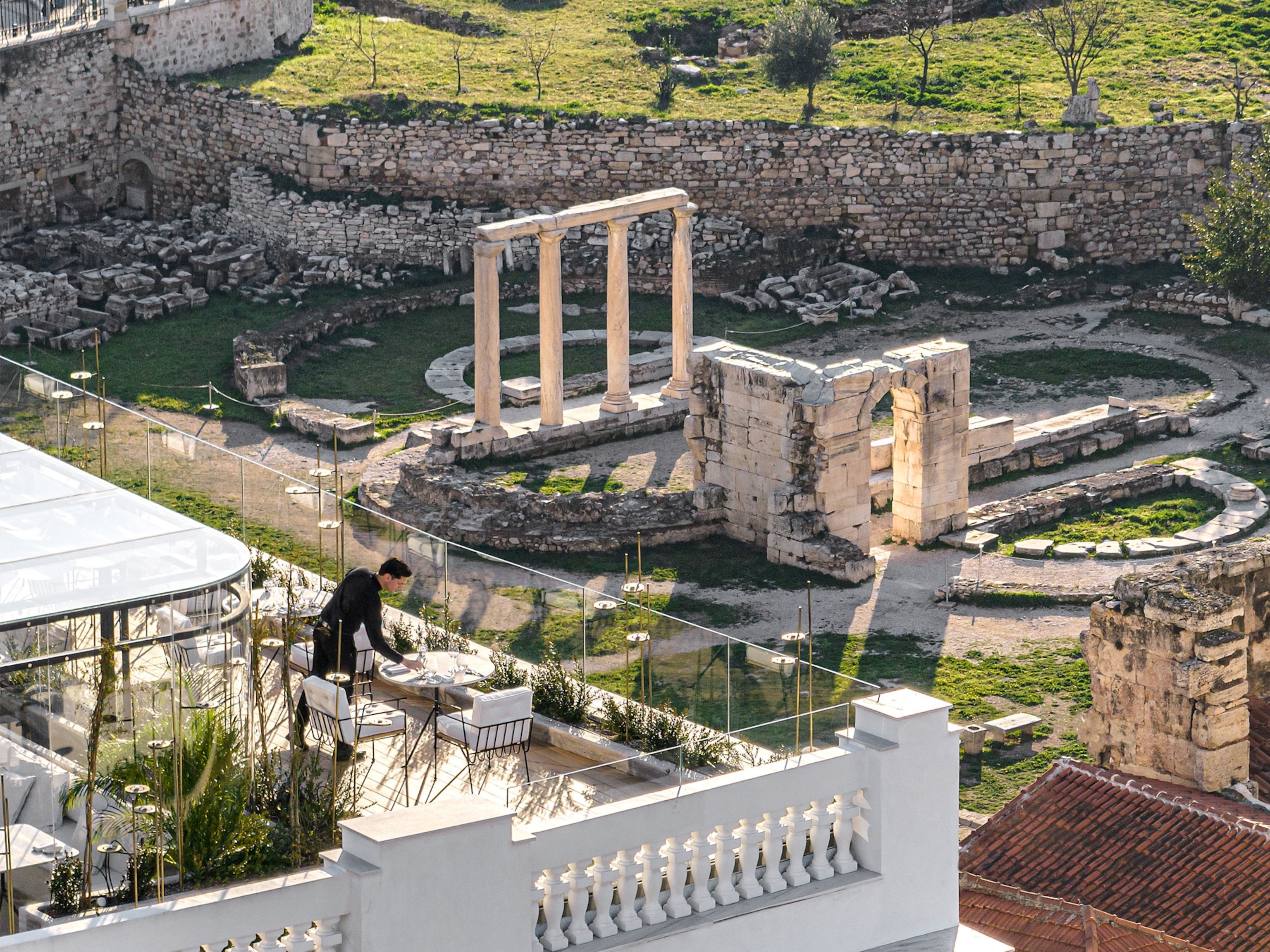 The Dolli Rooftop Restaurant, Located in the heart of ancient Athens, overlooks the Roman Agora, ancient stone ruins.