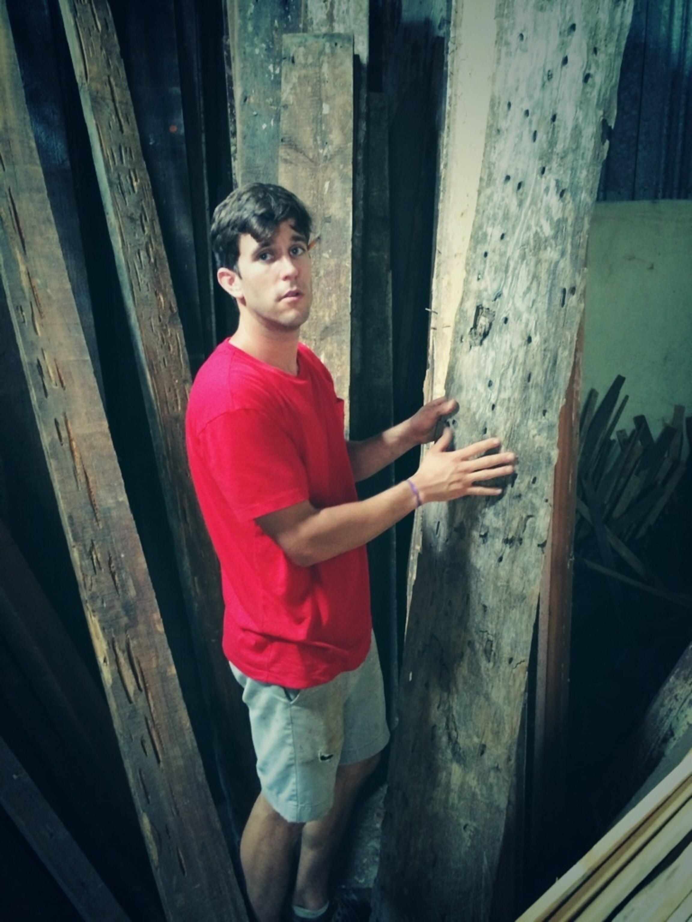 Designer Alex Geriner stacks 'Barge Wood', lumber that was used to built boats, then houses, and now his furniture in New Orleans. (Photo by Andrew Evans, National Geographic Travel)
