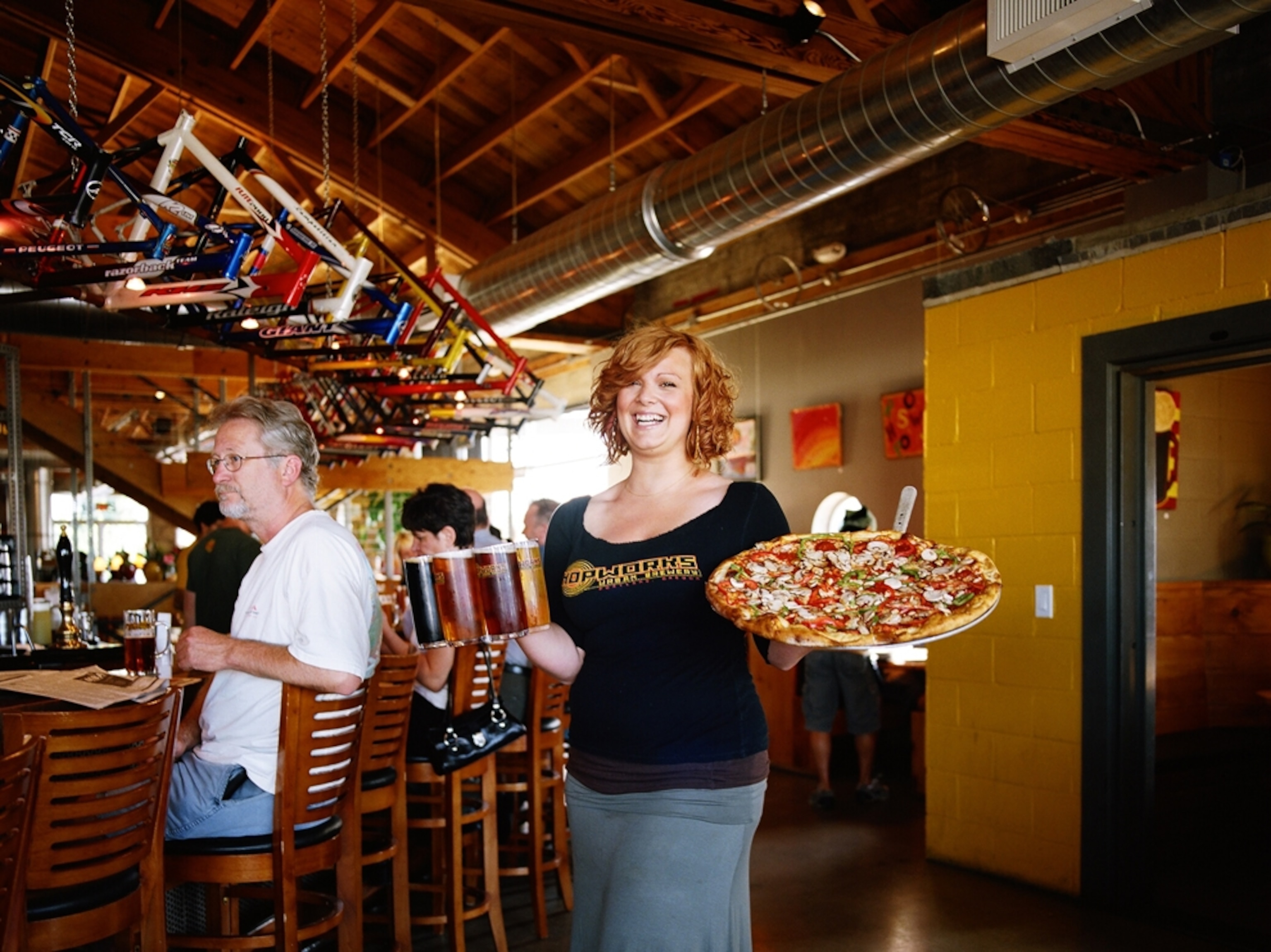 Waitress serves pizza and beer, Portland, Oregon