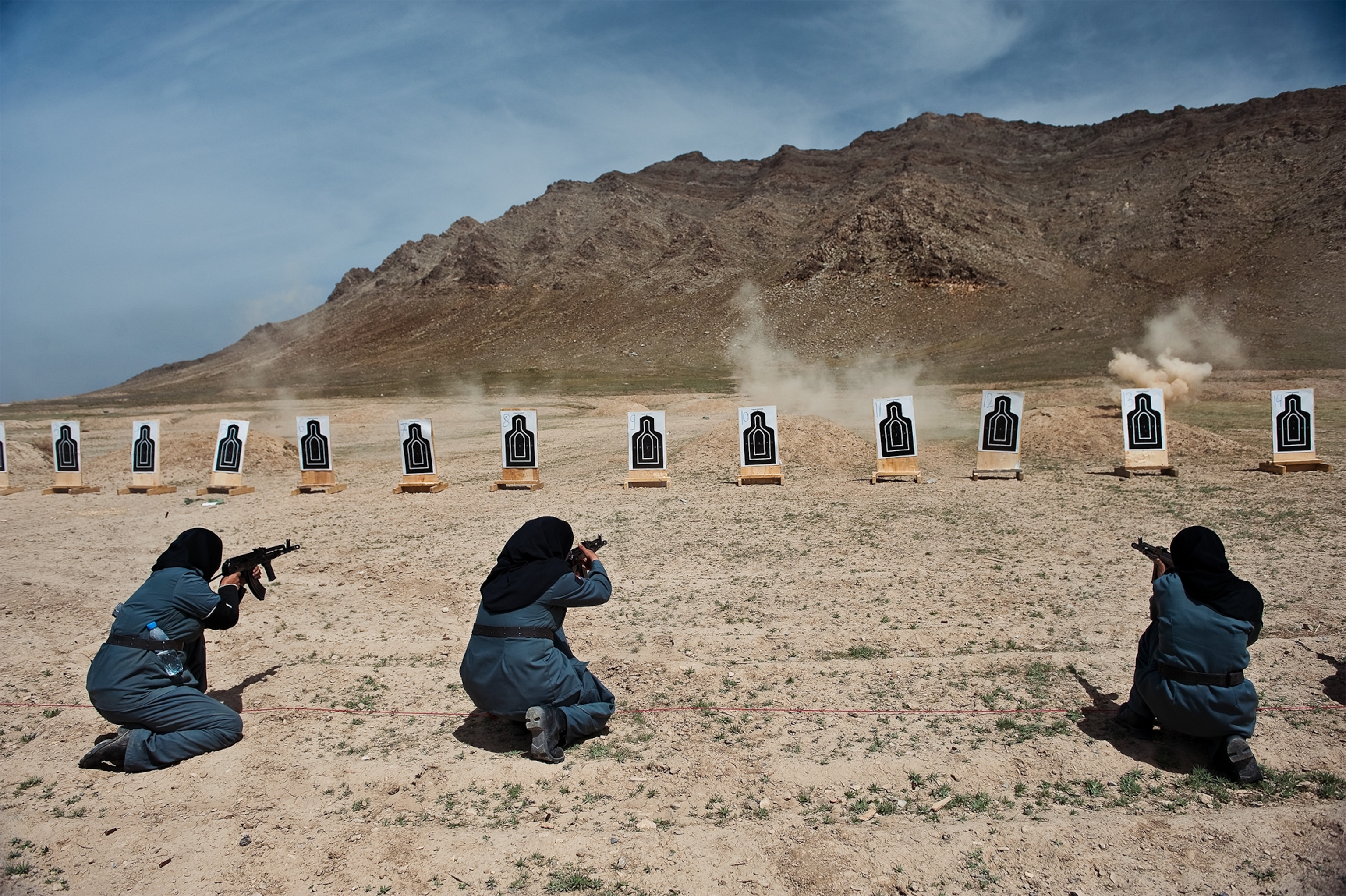 Afghan policewomen handling AMD-65 rifles at a firing range outside Kabul, Afghanistan