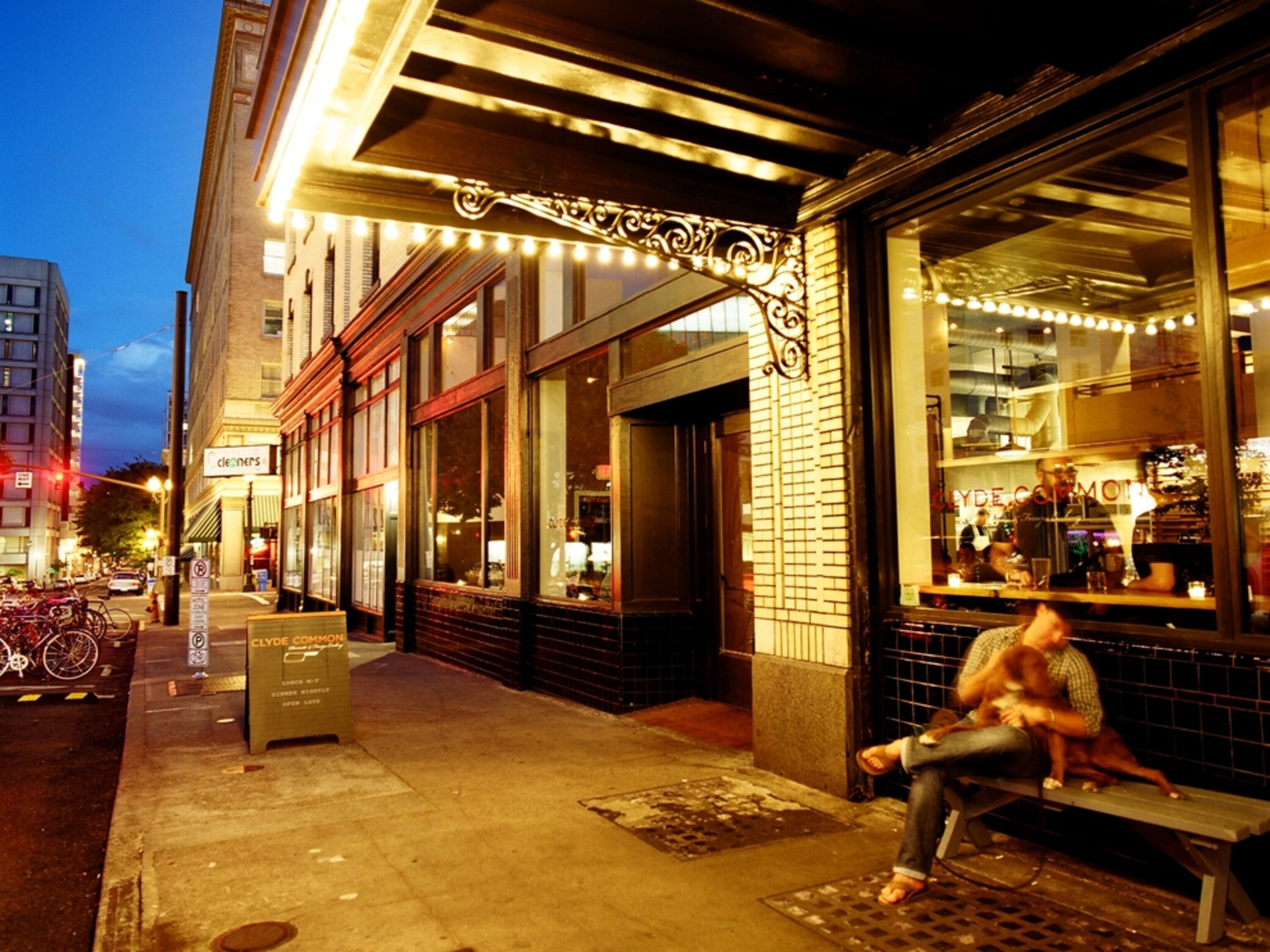 Man with dog outside Clyde Common, Portland, Oregon