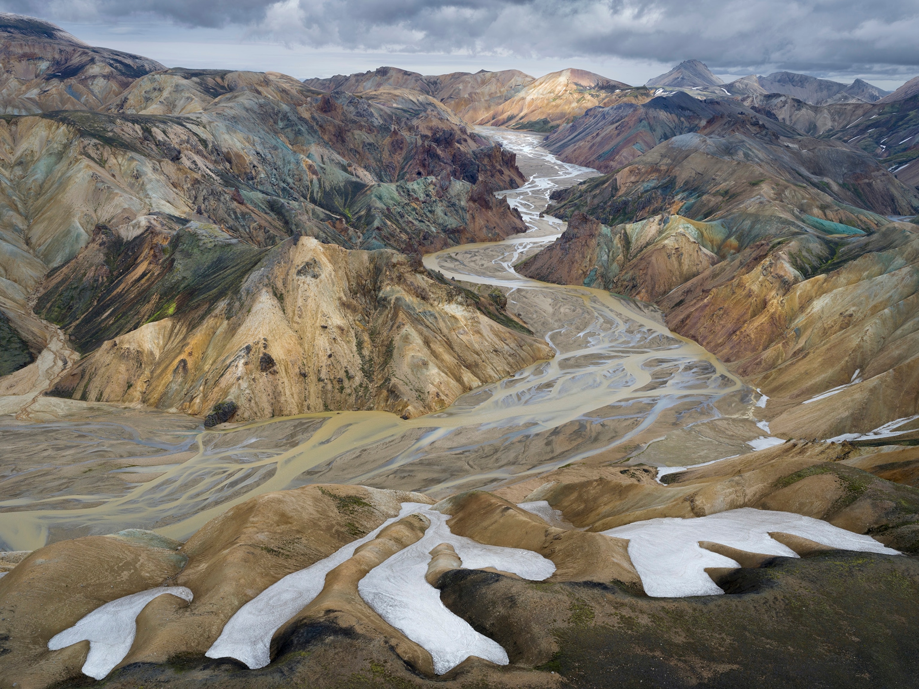 An overhead view of a valley running through a mountain range.