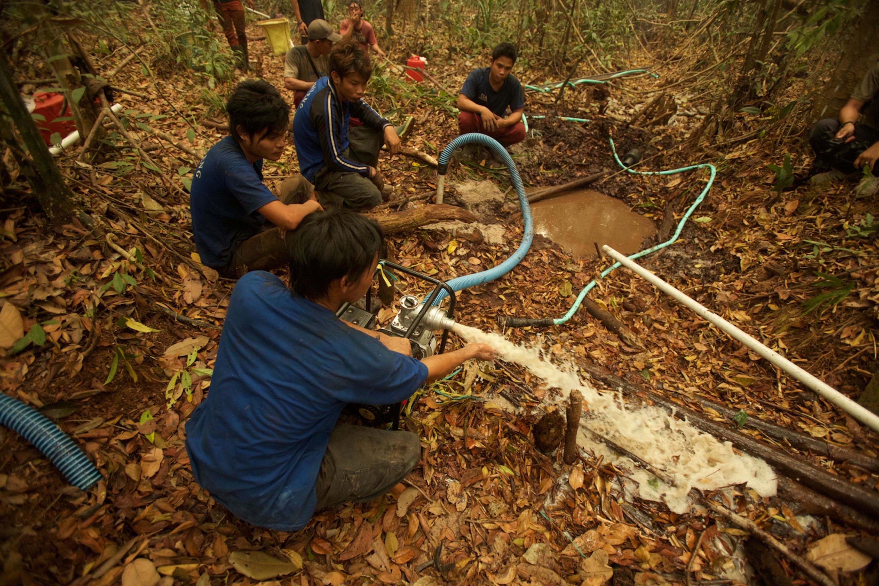 forest well drillers make a well in peat swamp forest to prepare to fight a forest fire