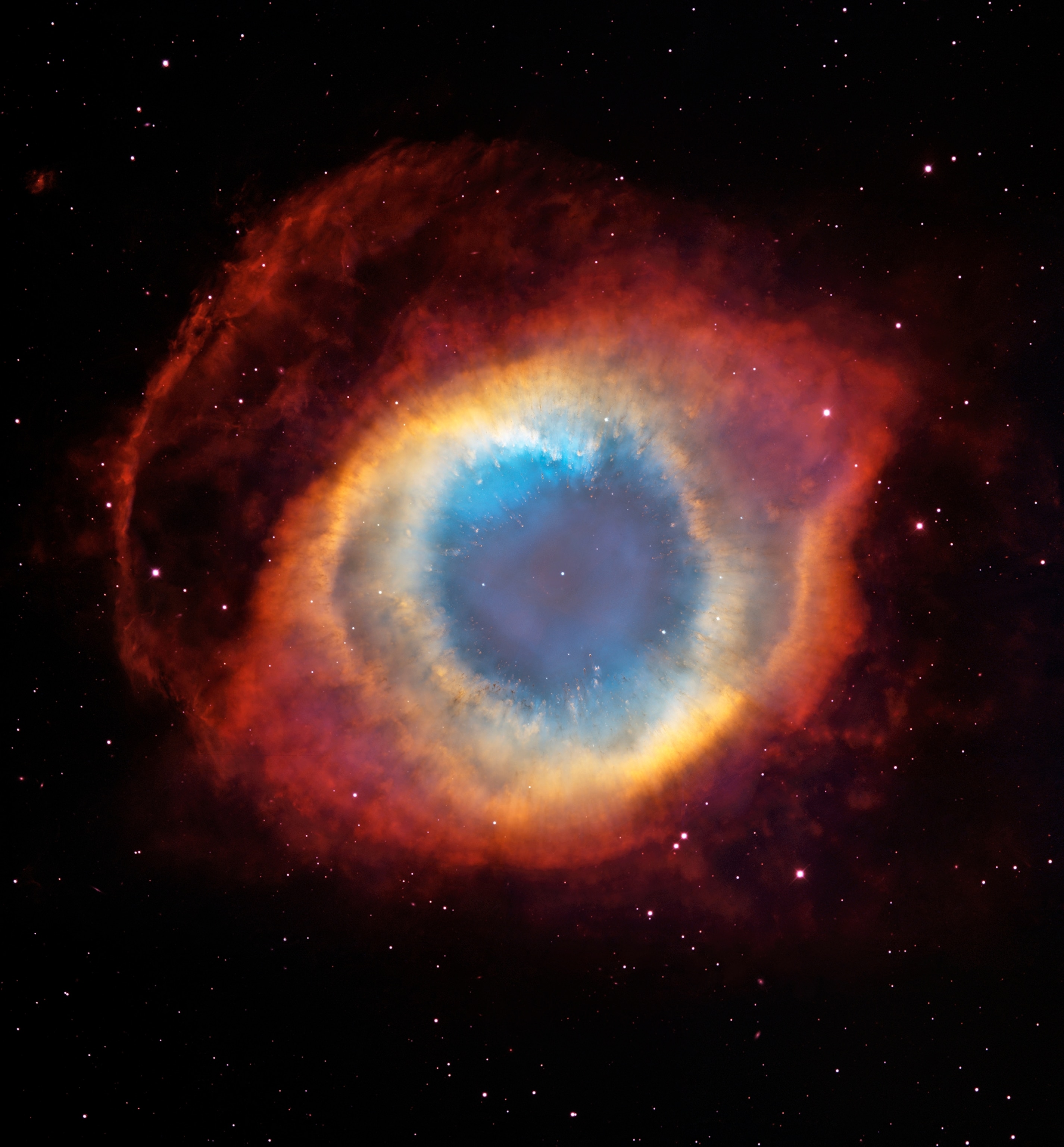 The Helix Nebula glows in its gaseous envelope expelled by a dying, sun-like star.
