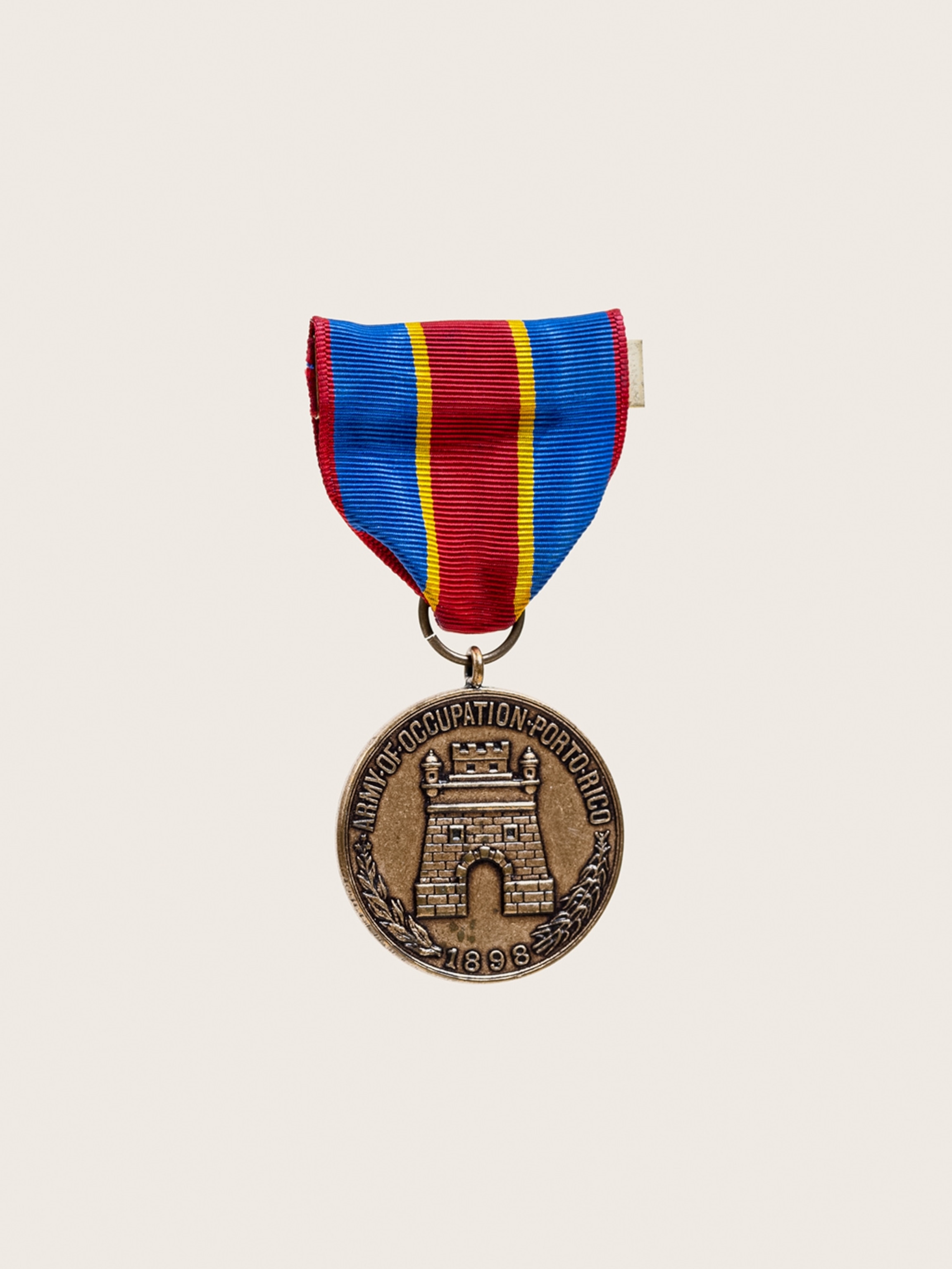 Bronse medal on red and blue ribbon.