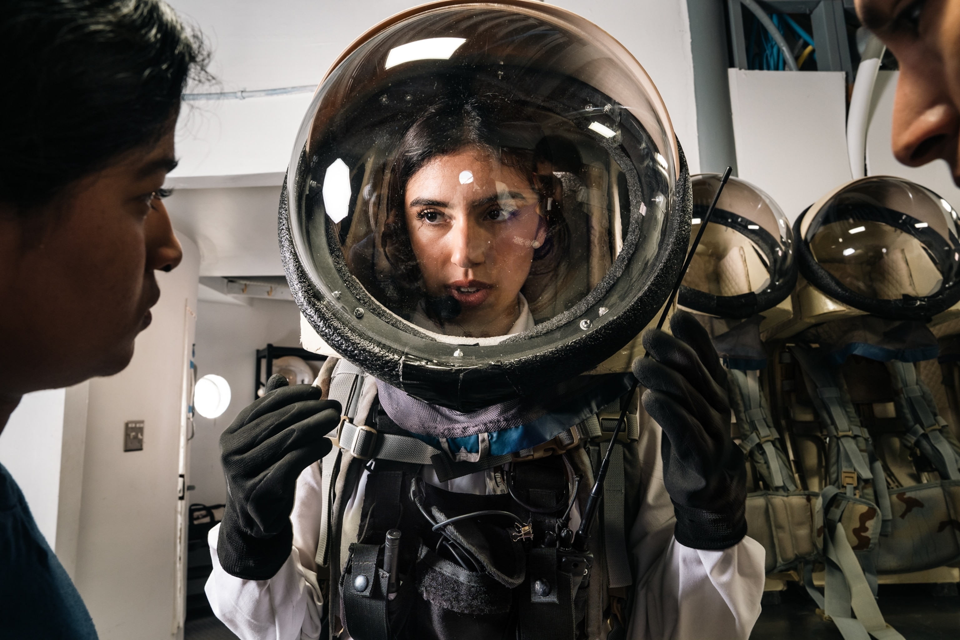 Commander Rym Chaïd putting on her spacesuit while preparing for an EVA on Sol 6 at Mars Desert Research Station outside of Hanksville, Utah on October 18, 2025.