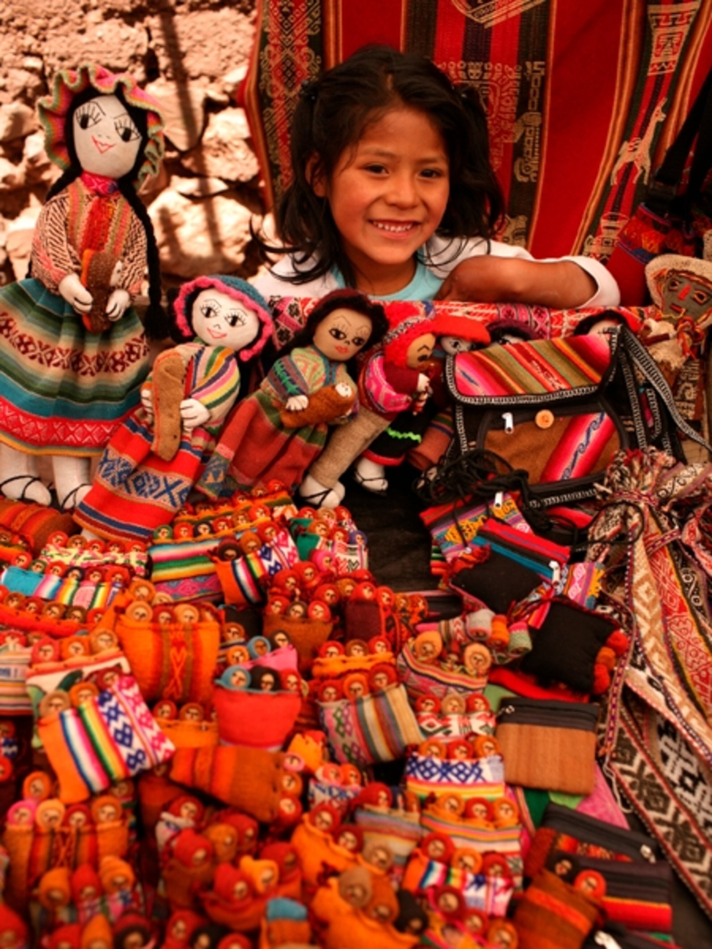 Photo: girl with dolls in the village of Pisac .