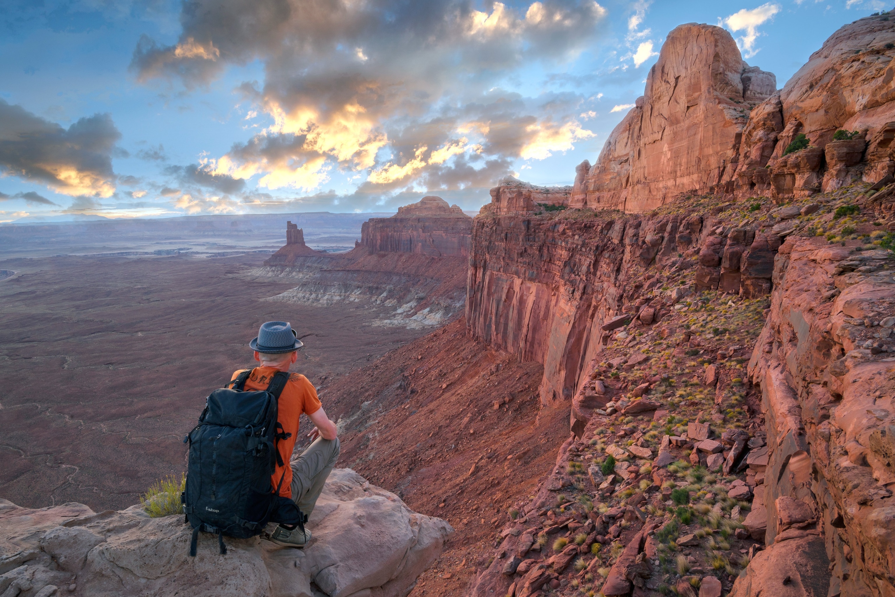 a man looking at a canyon at Island in the Sky in Canyonlands National Park, Utah