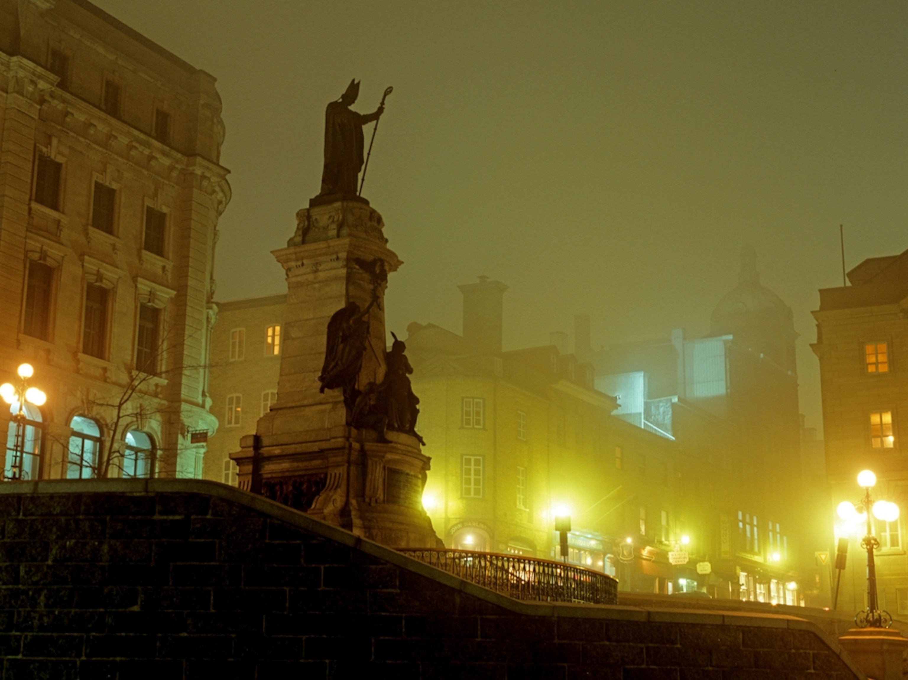 Statue and city scene at night in Quebec City, Canada