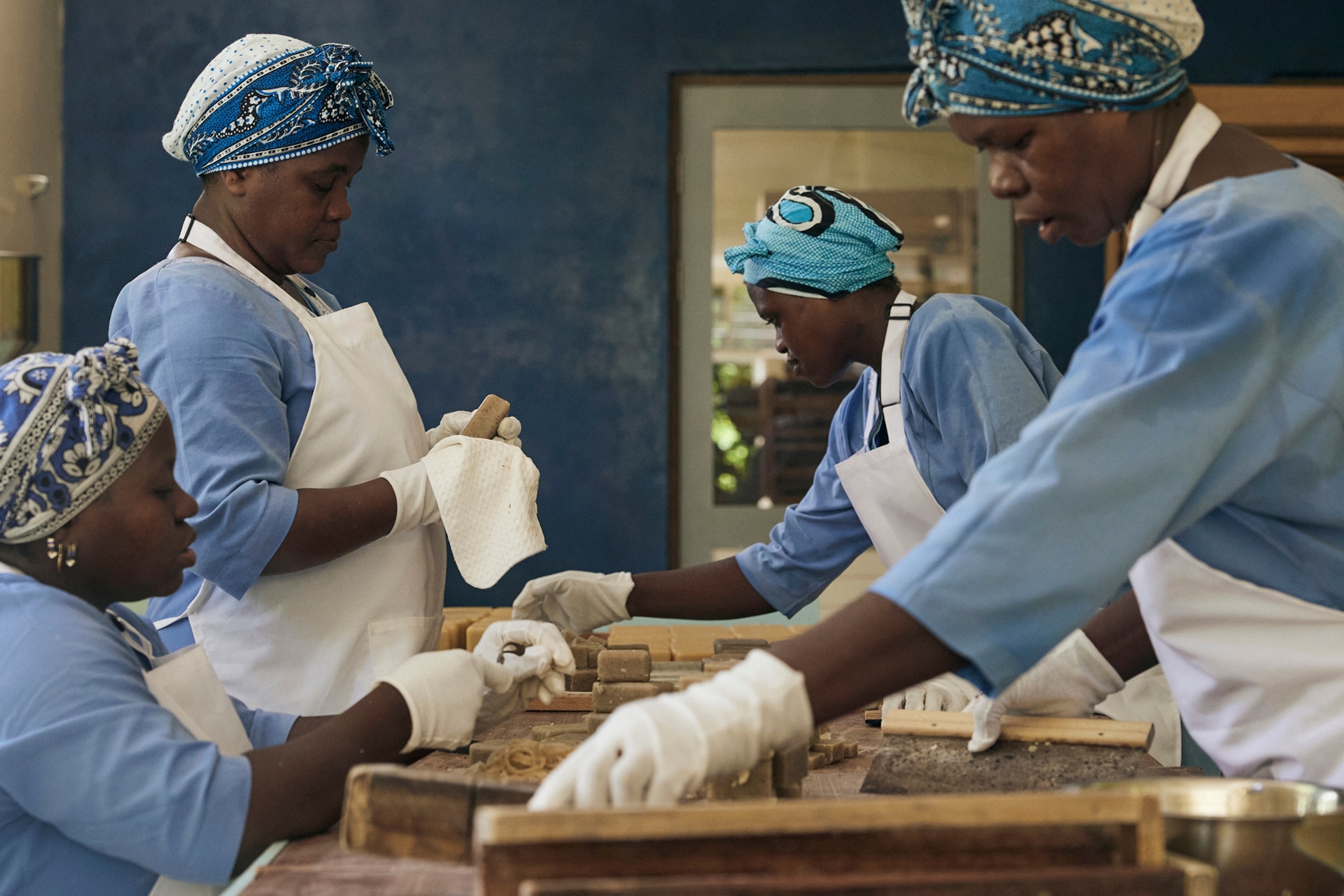 A group of women working around one table in a lab.