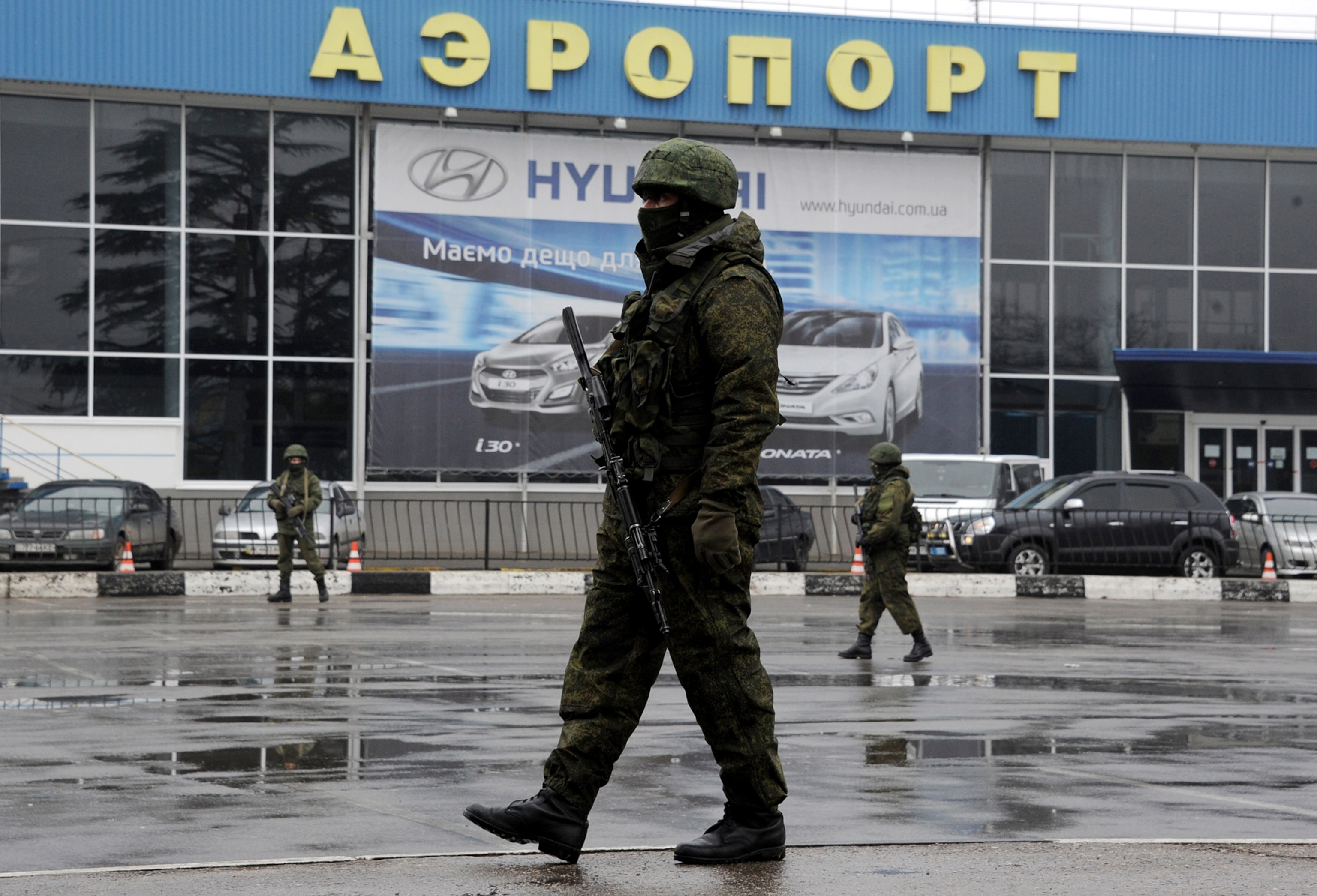 Unidentified armed men patrol outside of Simferopol airport, on February 28, 2014.