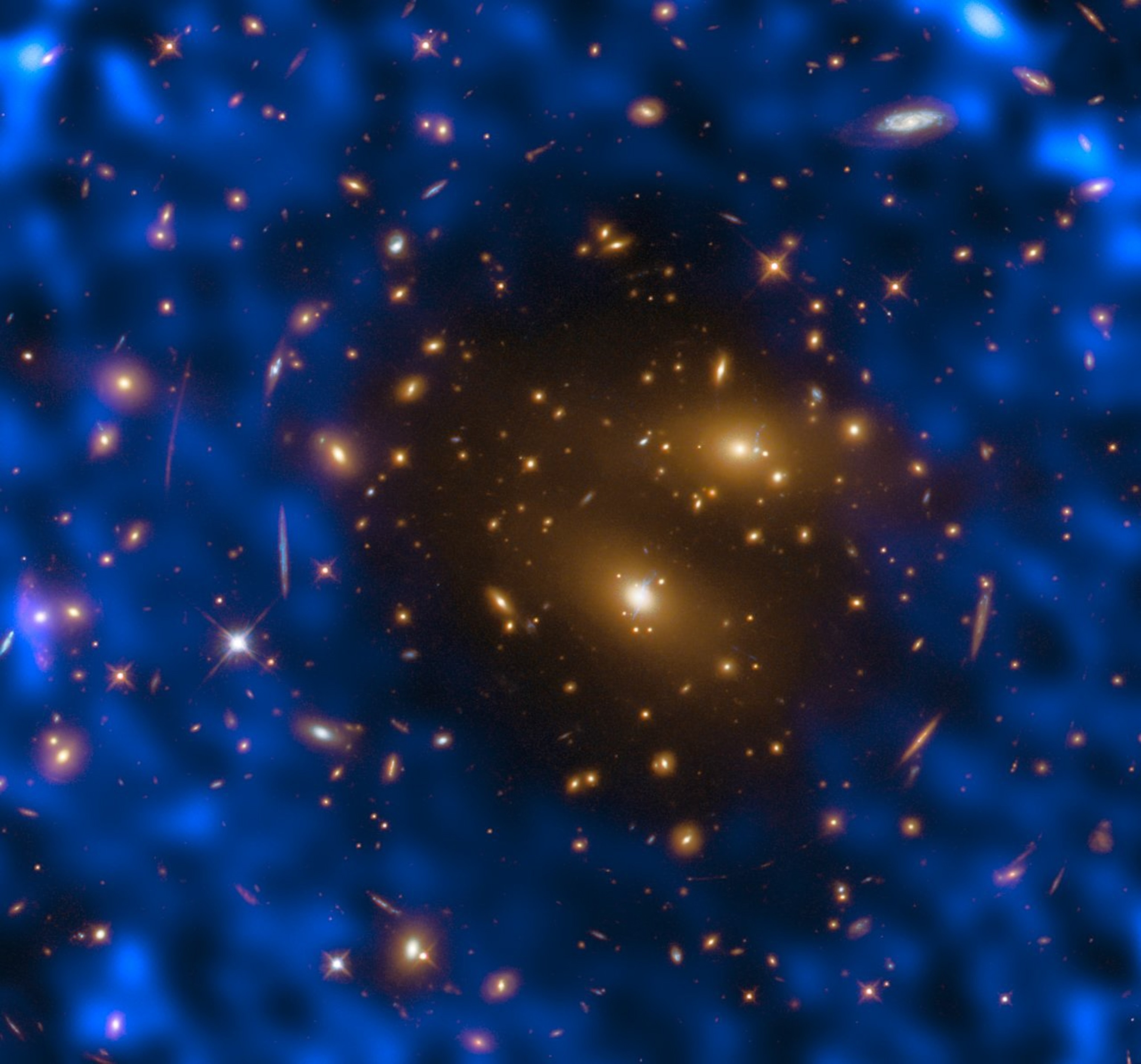 A cluster of galaxies, which appear as golden stars, surrounded by a foggy blue-purple haze