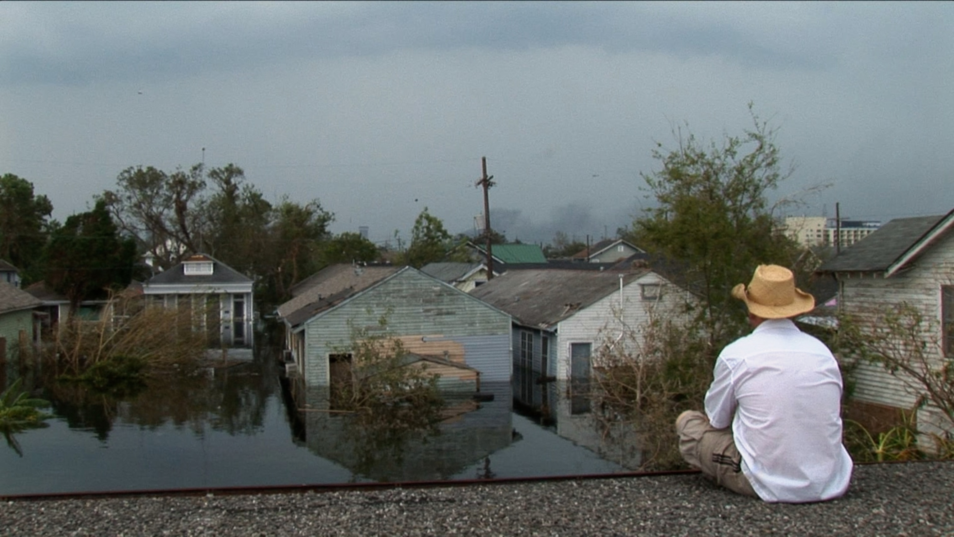 A man is stranded on a rooftop after Hurricane Katrina.