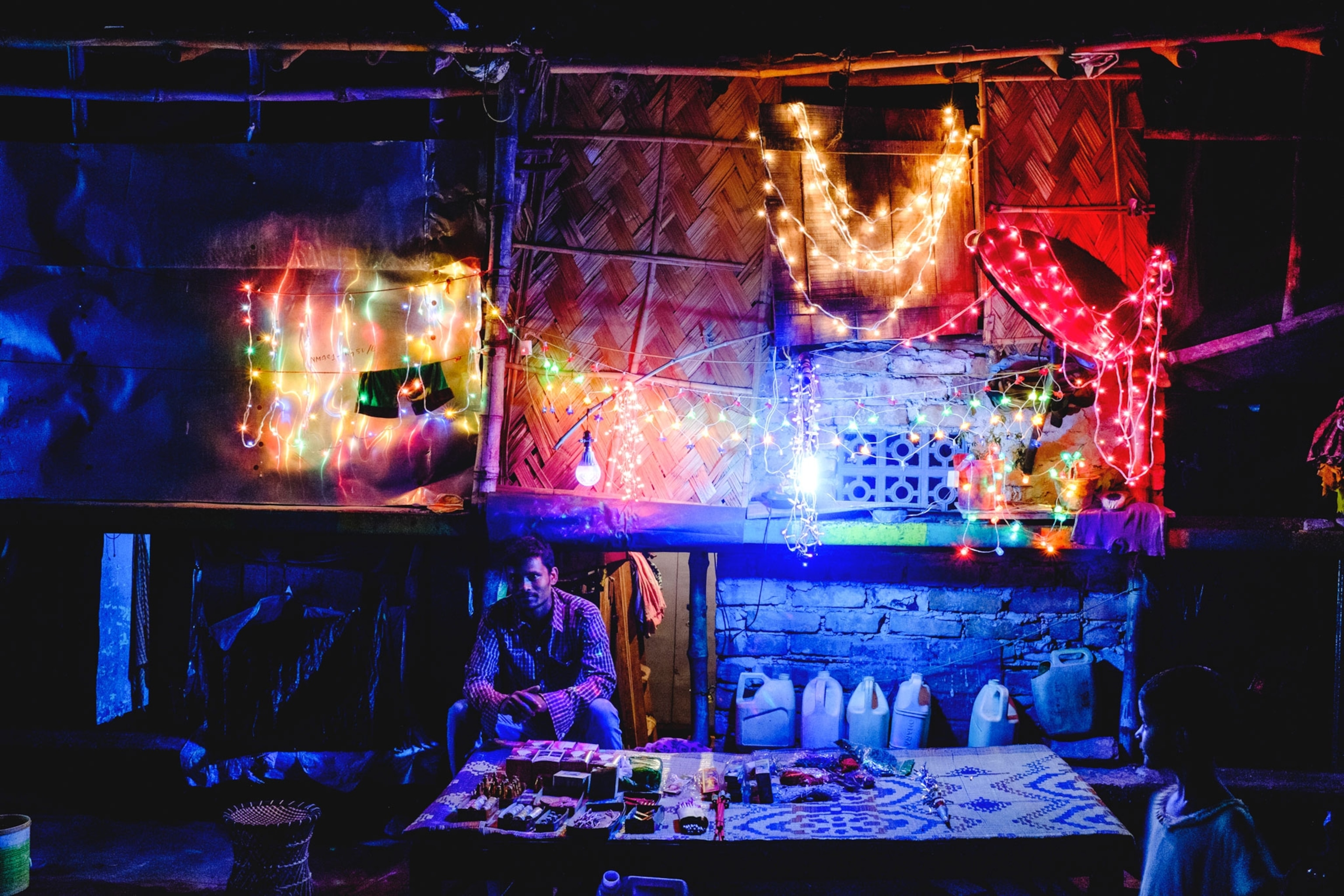 a man selling diwali lights in front of his house