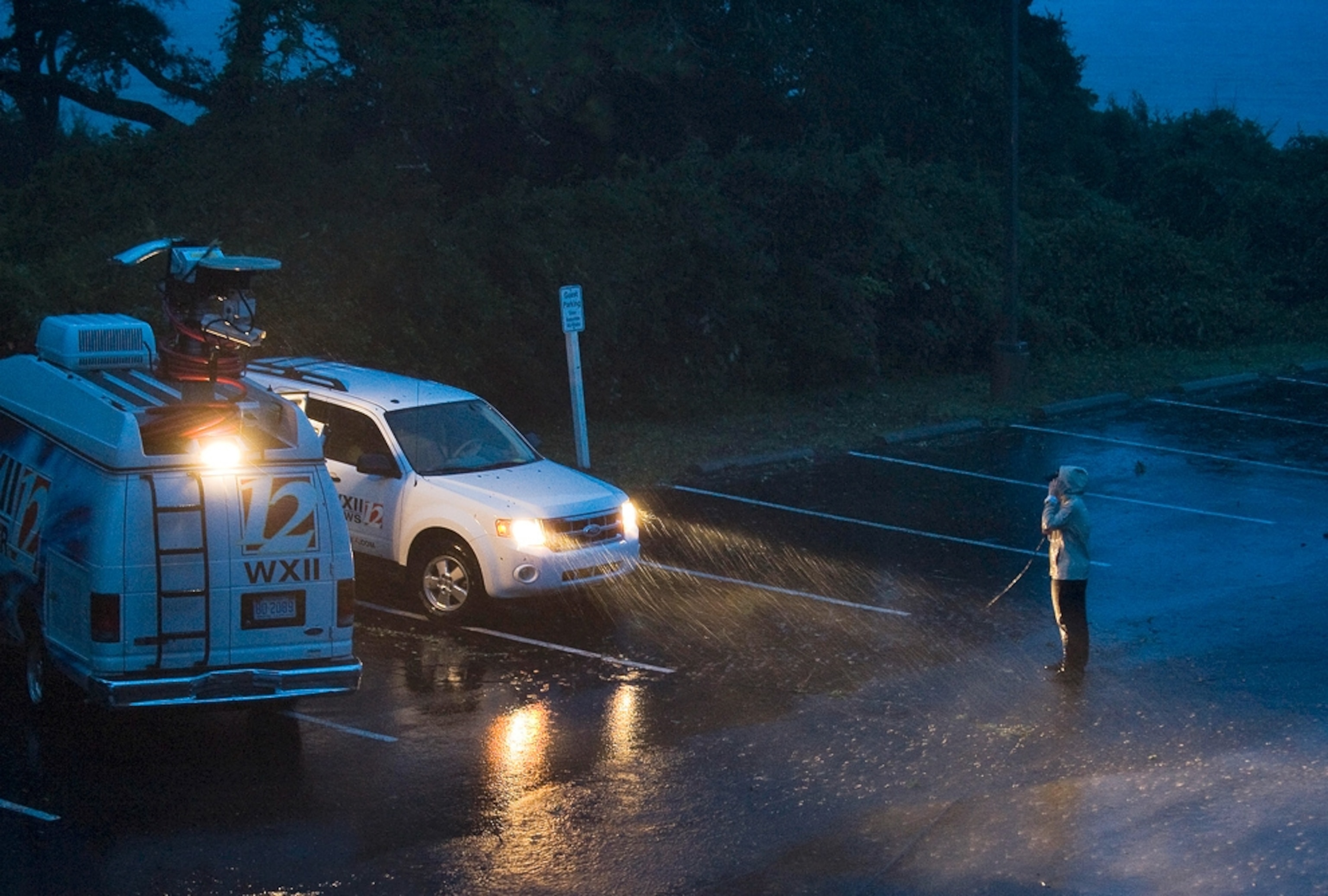 Hurricane Irene picture: a reporter does a newscast from a parking lot in North Carolina