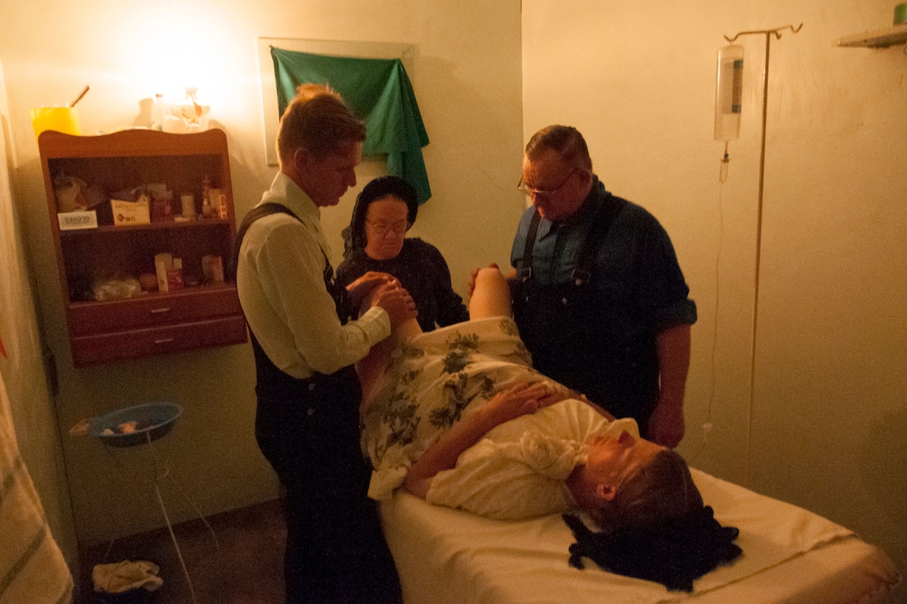 Elisabeth gives birth to her sixth son as her husband Frans looks on. The doctor and nurse are both self-taught. Nueva Esperanza Colony, Bolivia. 2008