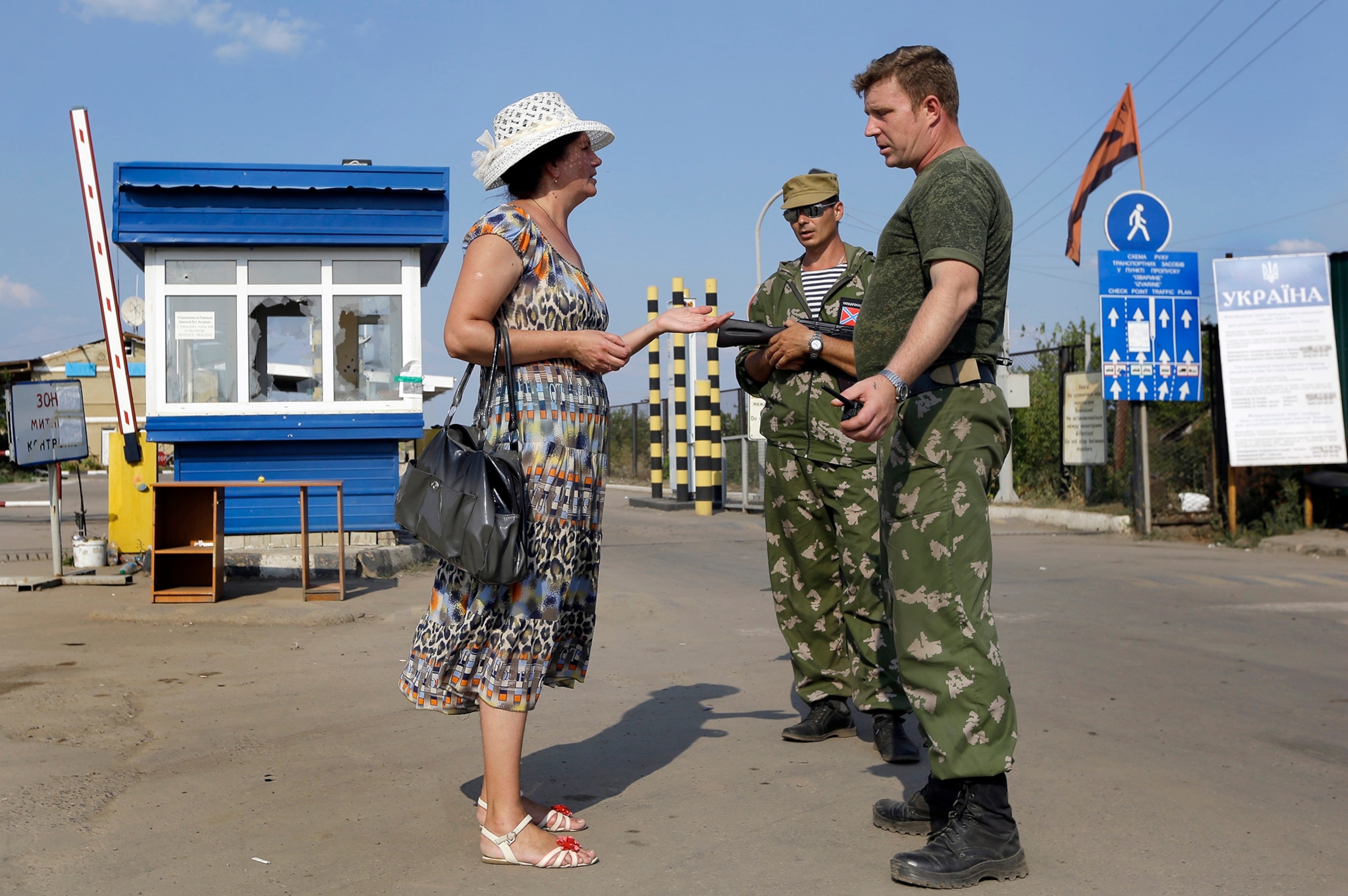A Ukrainian soldier stands on a tank in a military camp, near the eastern Ukrainian town of Rassypnoe.