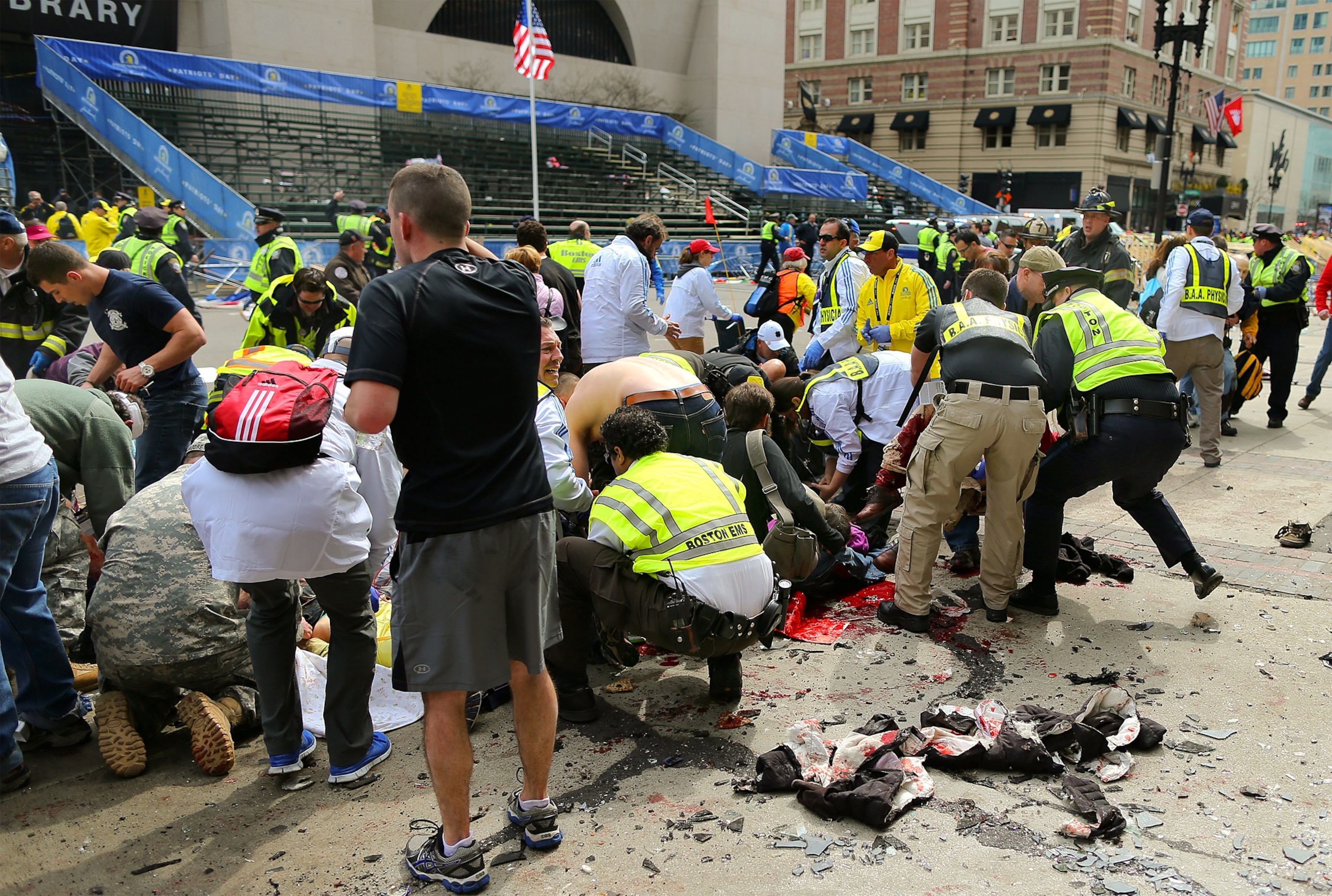 Injured people receive medical attention at the site of a bombing in Boston, Massachusetts.