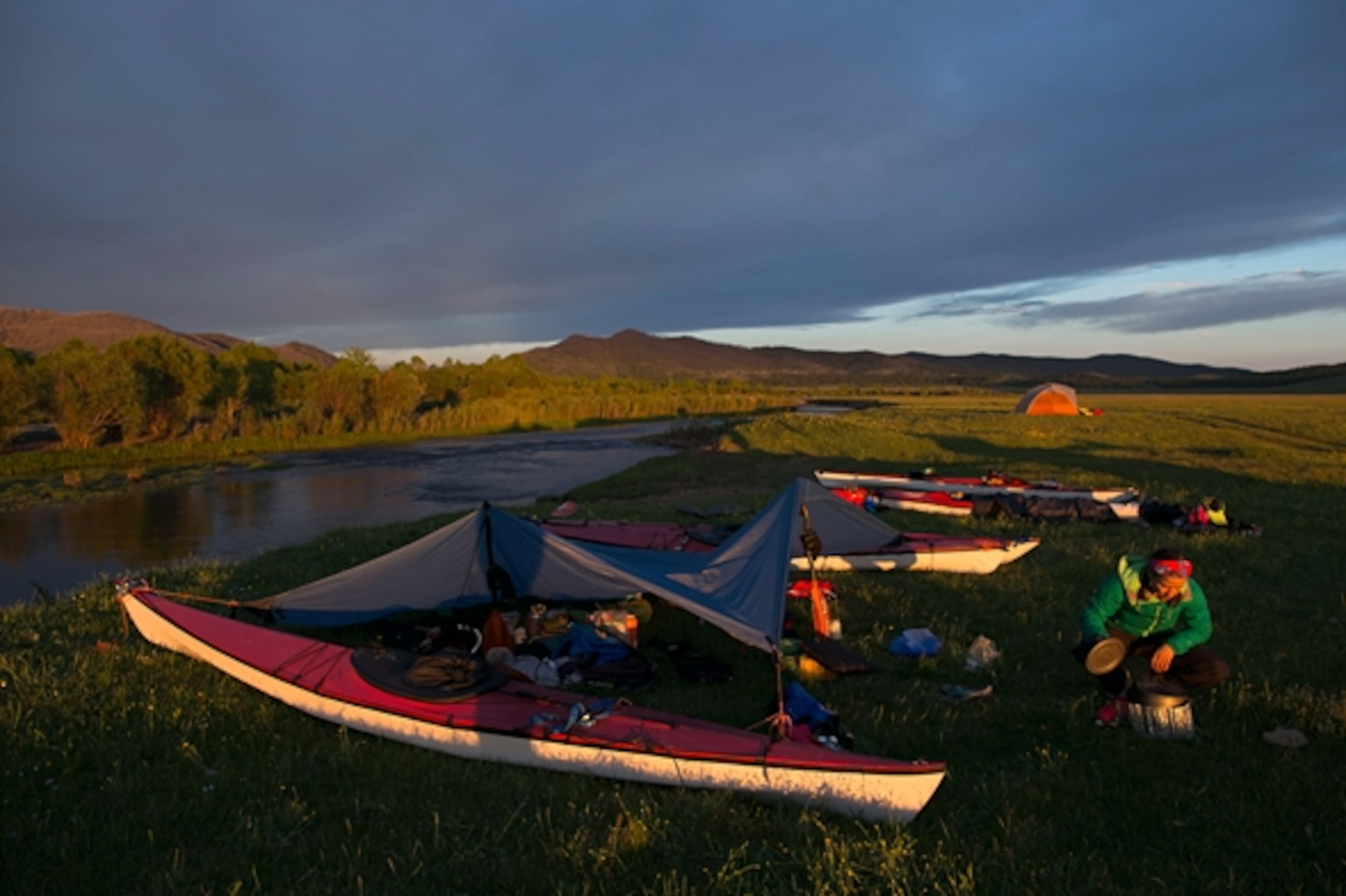 Amber checking stove and overall view of campsite; Photograph by Krystle Wright