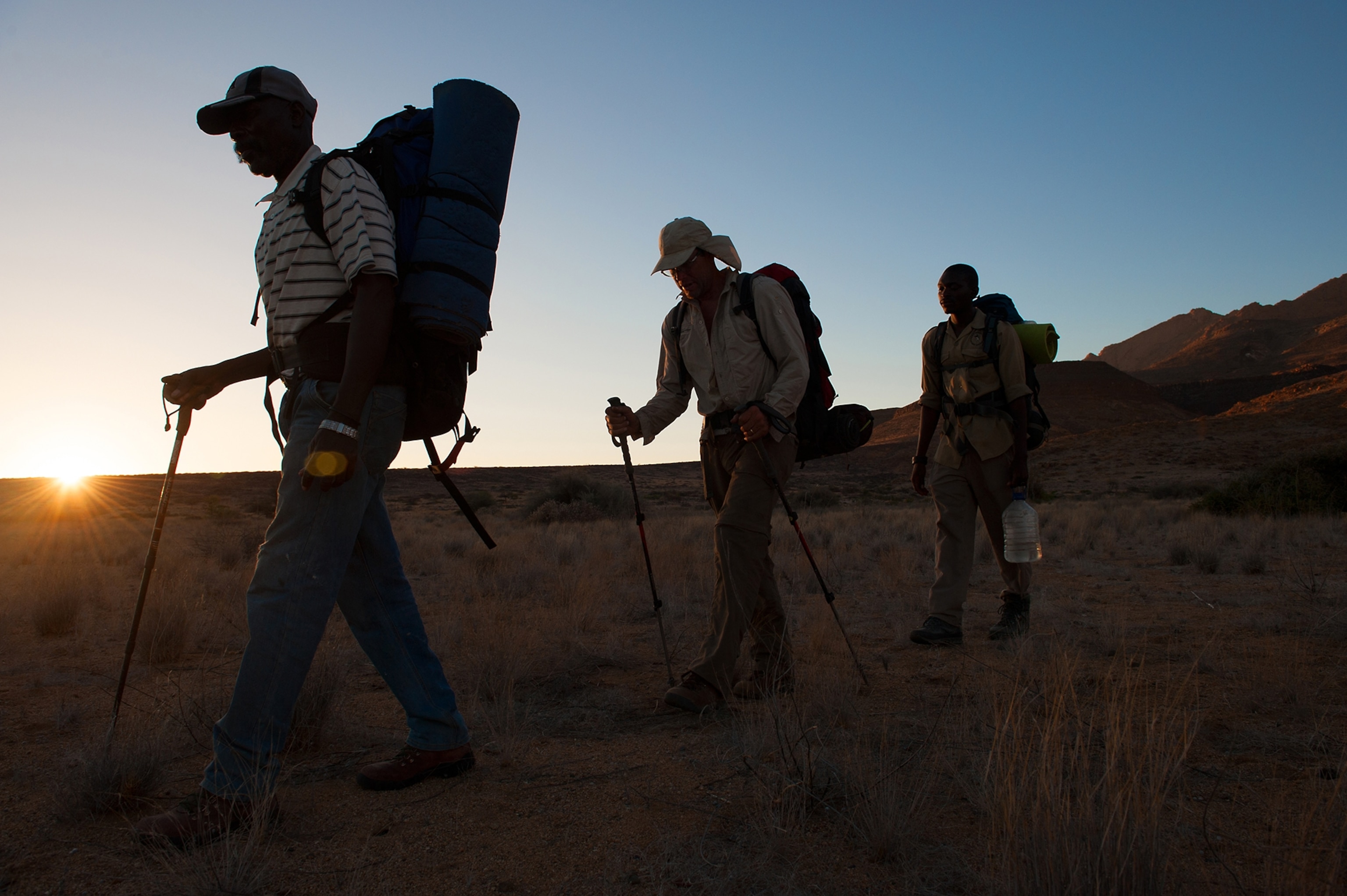 Mark Jenkins hiking away from Brandberg with his guides
