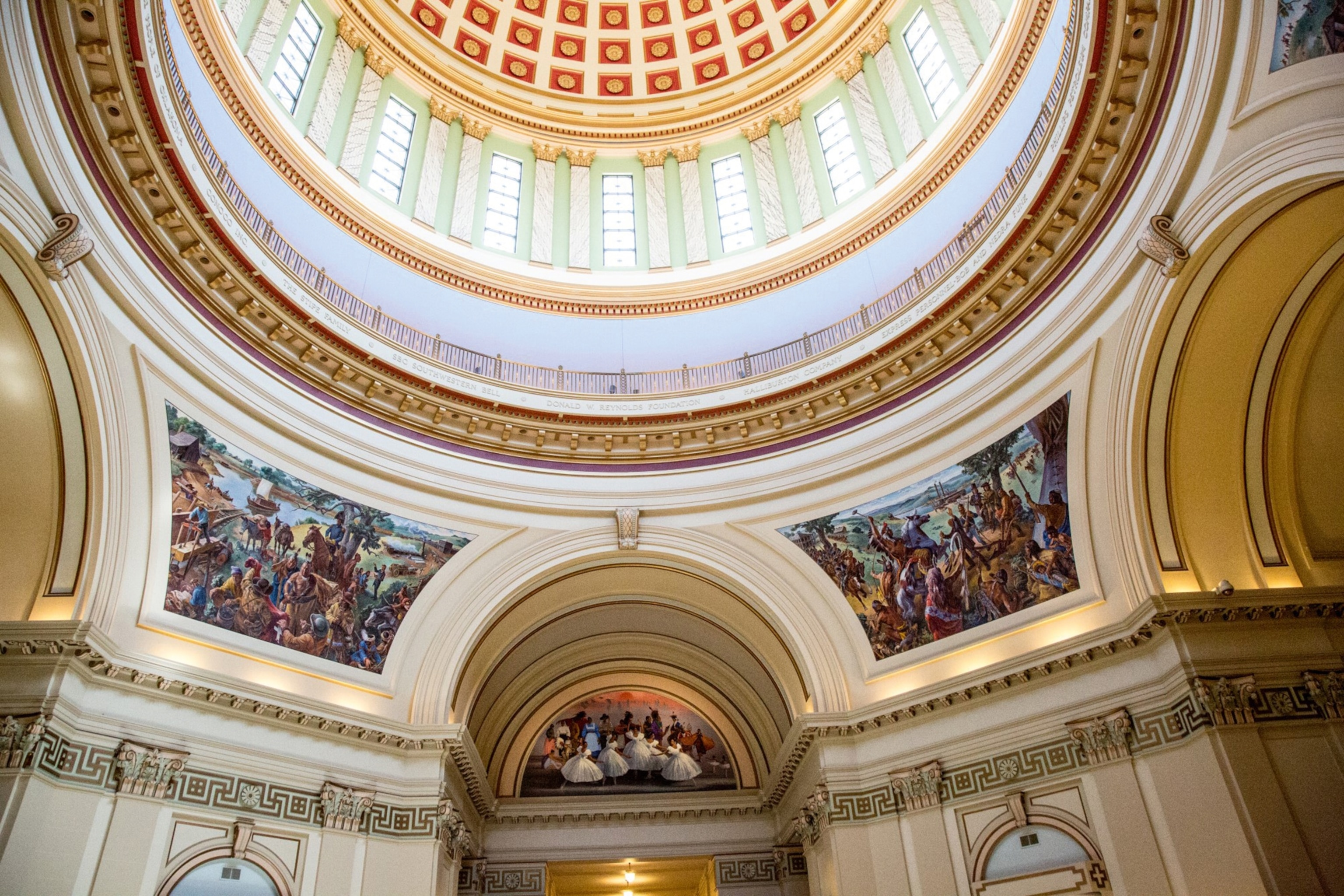 Colourful artworks and an elaborate domed roof are seen inside the Oklahoma State Capitol building.