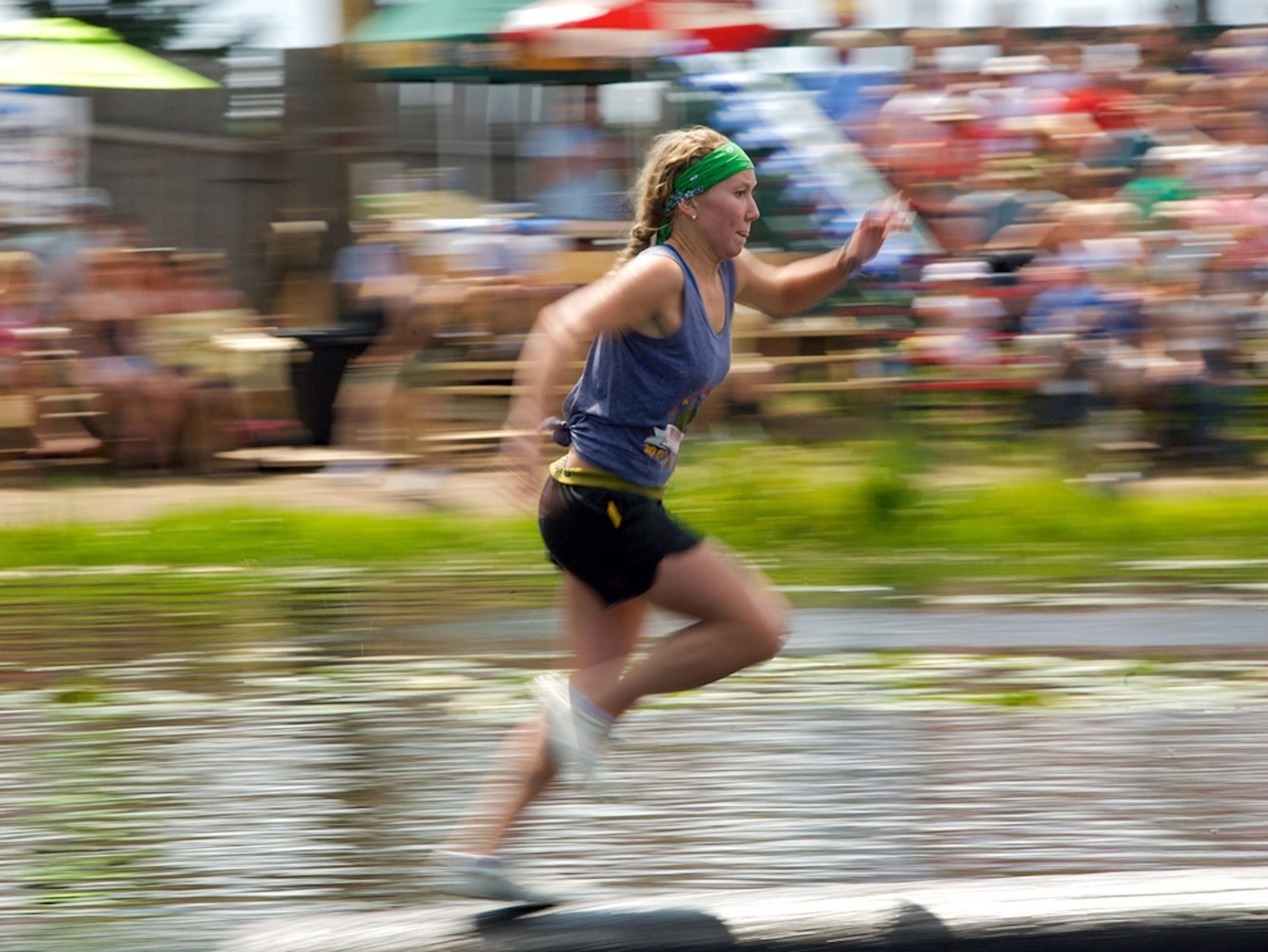 Woman running over logs
