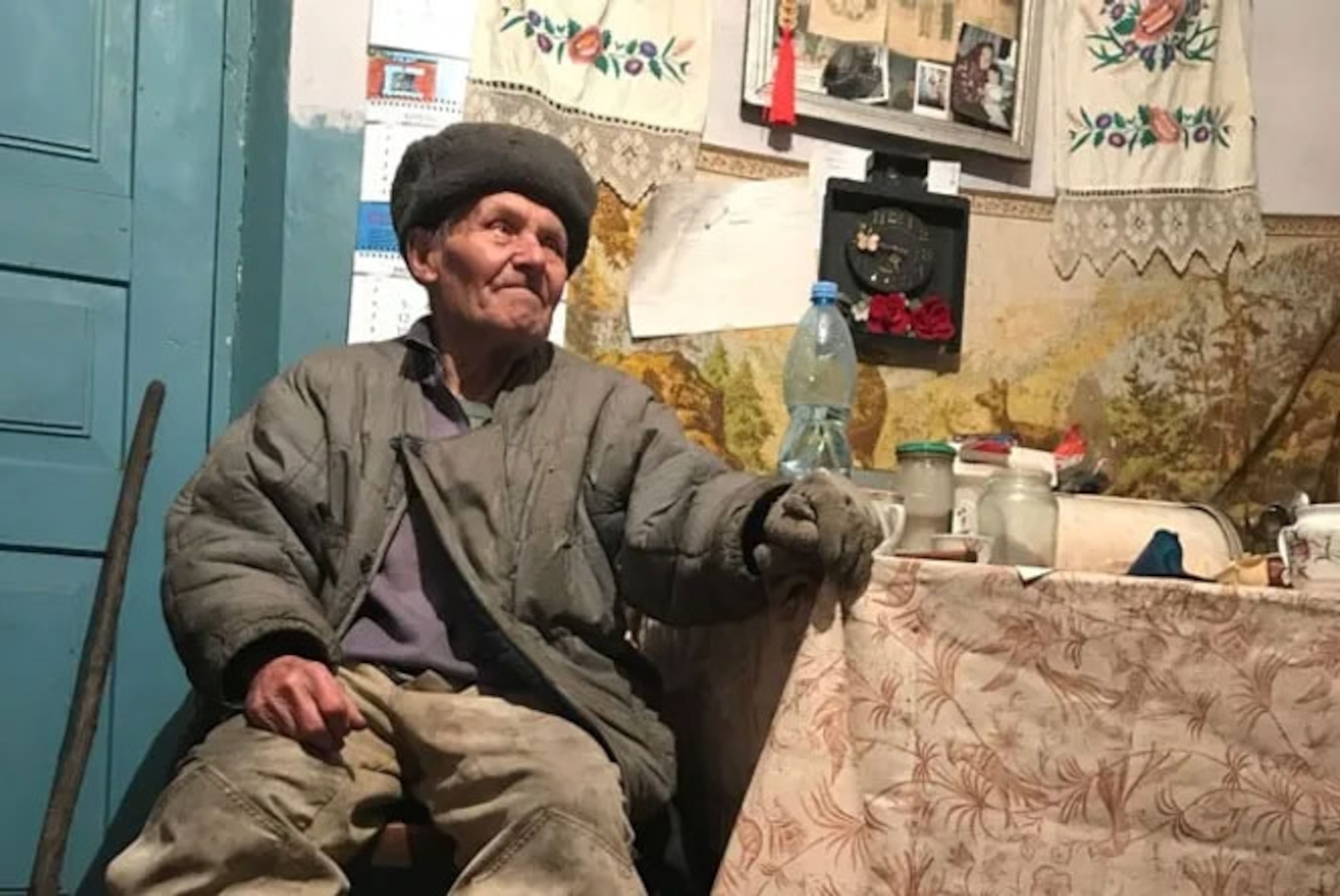 old man photographed inside home.