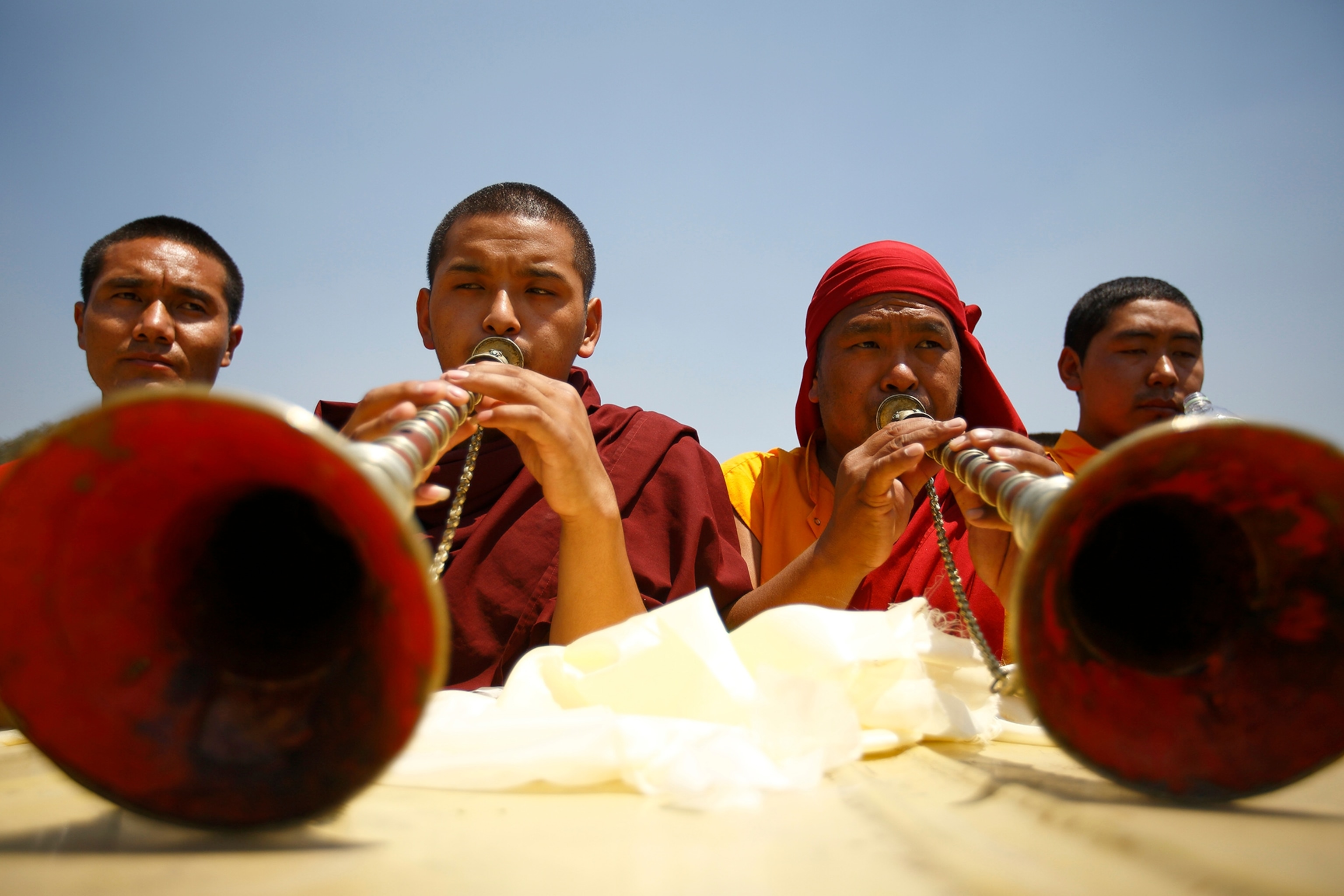 a monk setting fire to the body of a sherpa during a cremation ceremony.