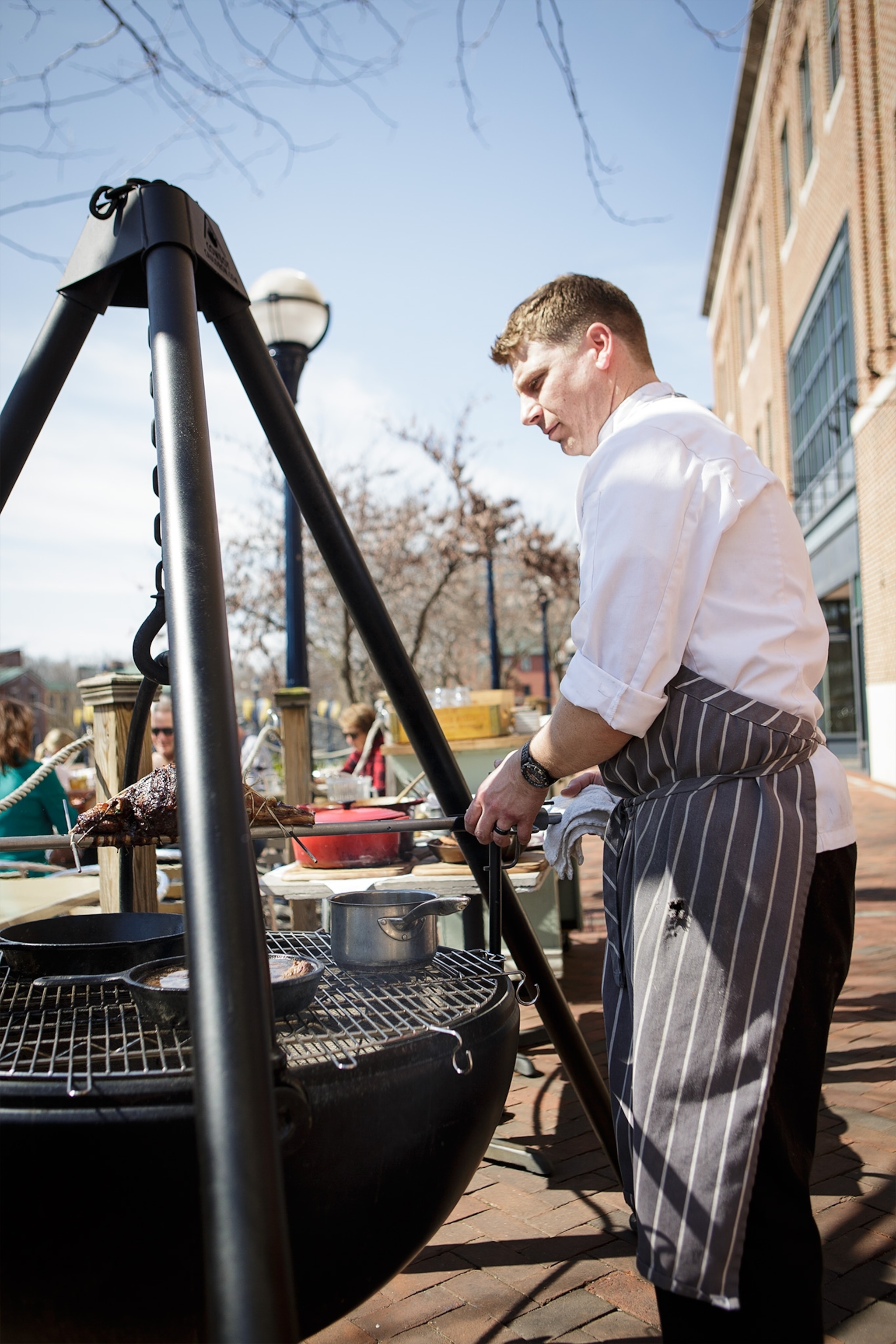 Chef Jeff Beard cooks beans and meat on his Civil War-style cauldron on the patio at Wine and Food. Photograph by Becky Harlan