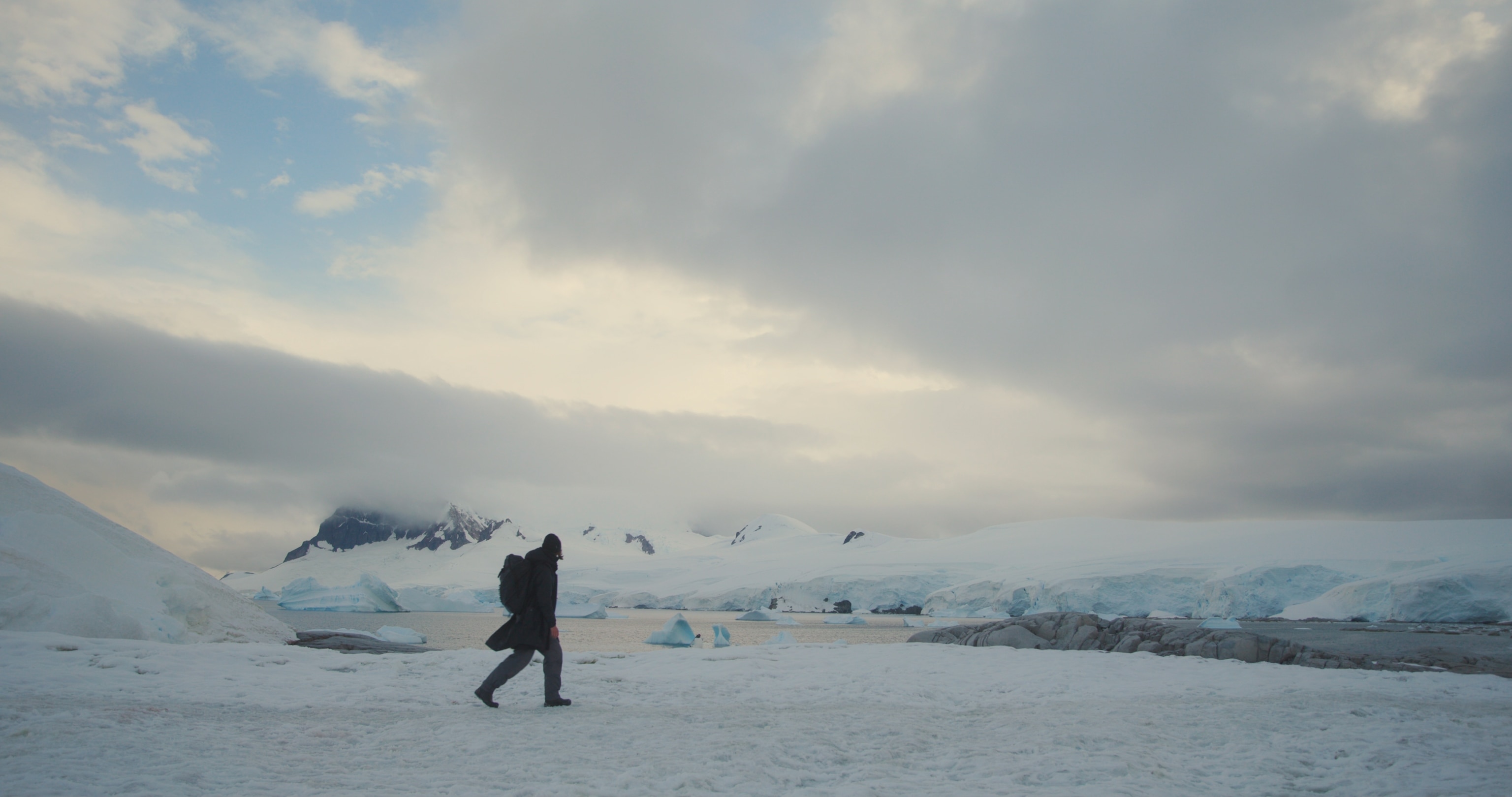 a person walking across the ice in Antarctica.