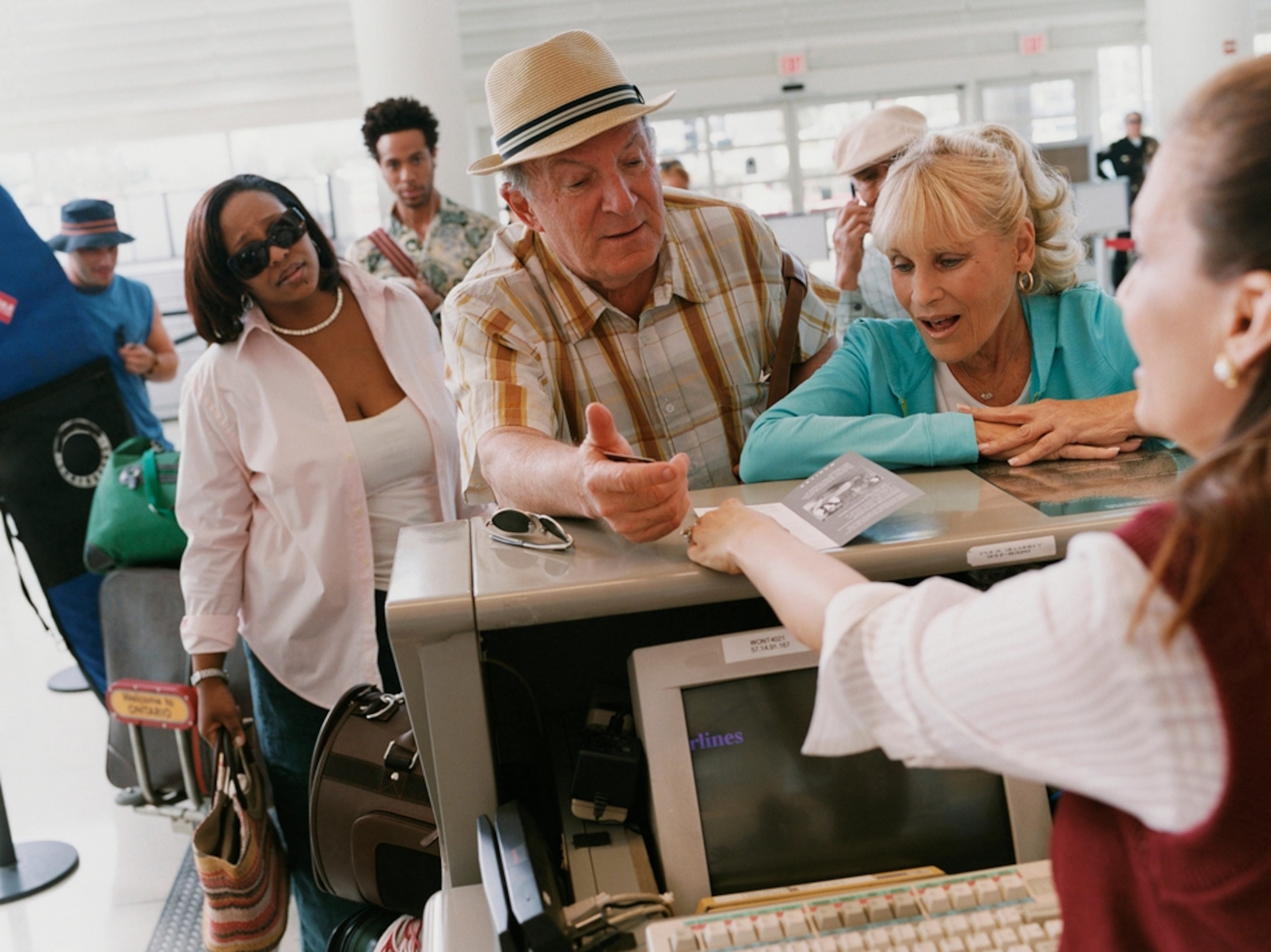 Senior couple check in at airport