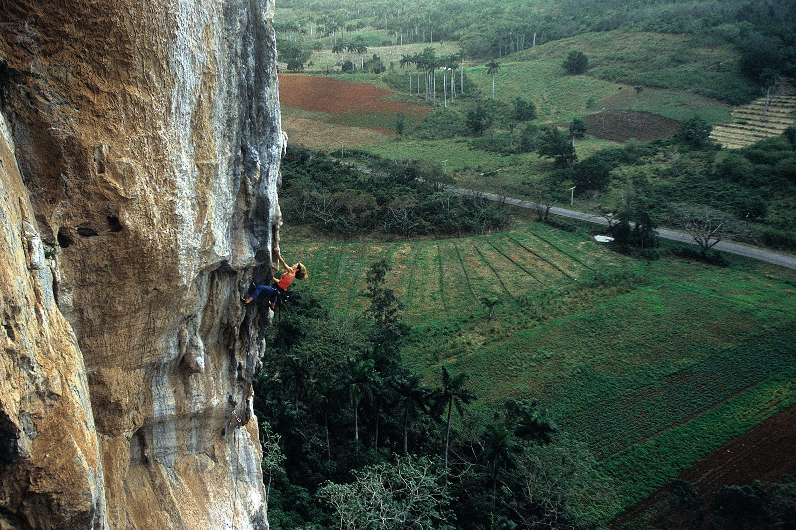 a rock climber climbing in Vinales, Cuba