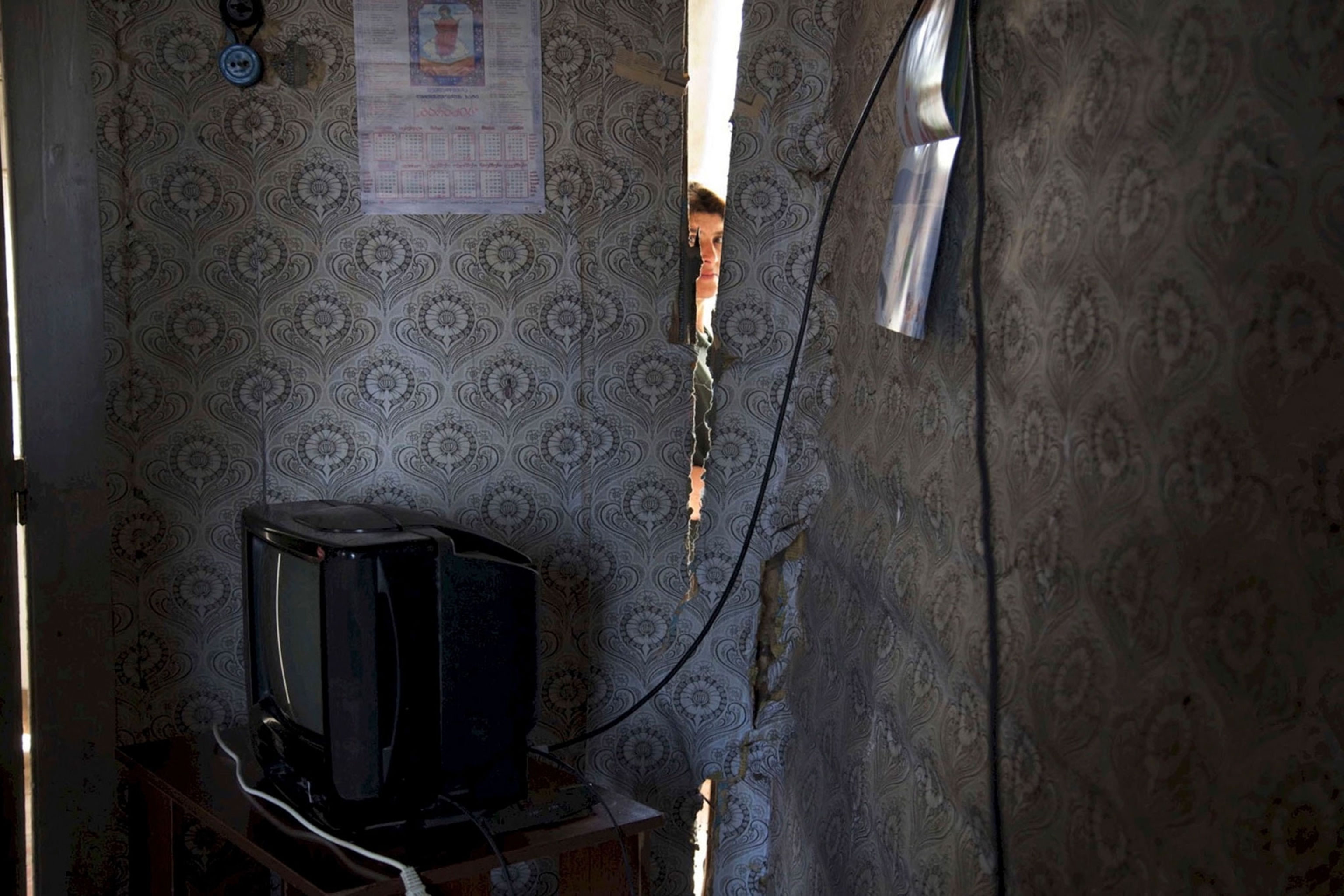 a room with a hole torn into the wall due to the mining beneath the house